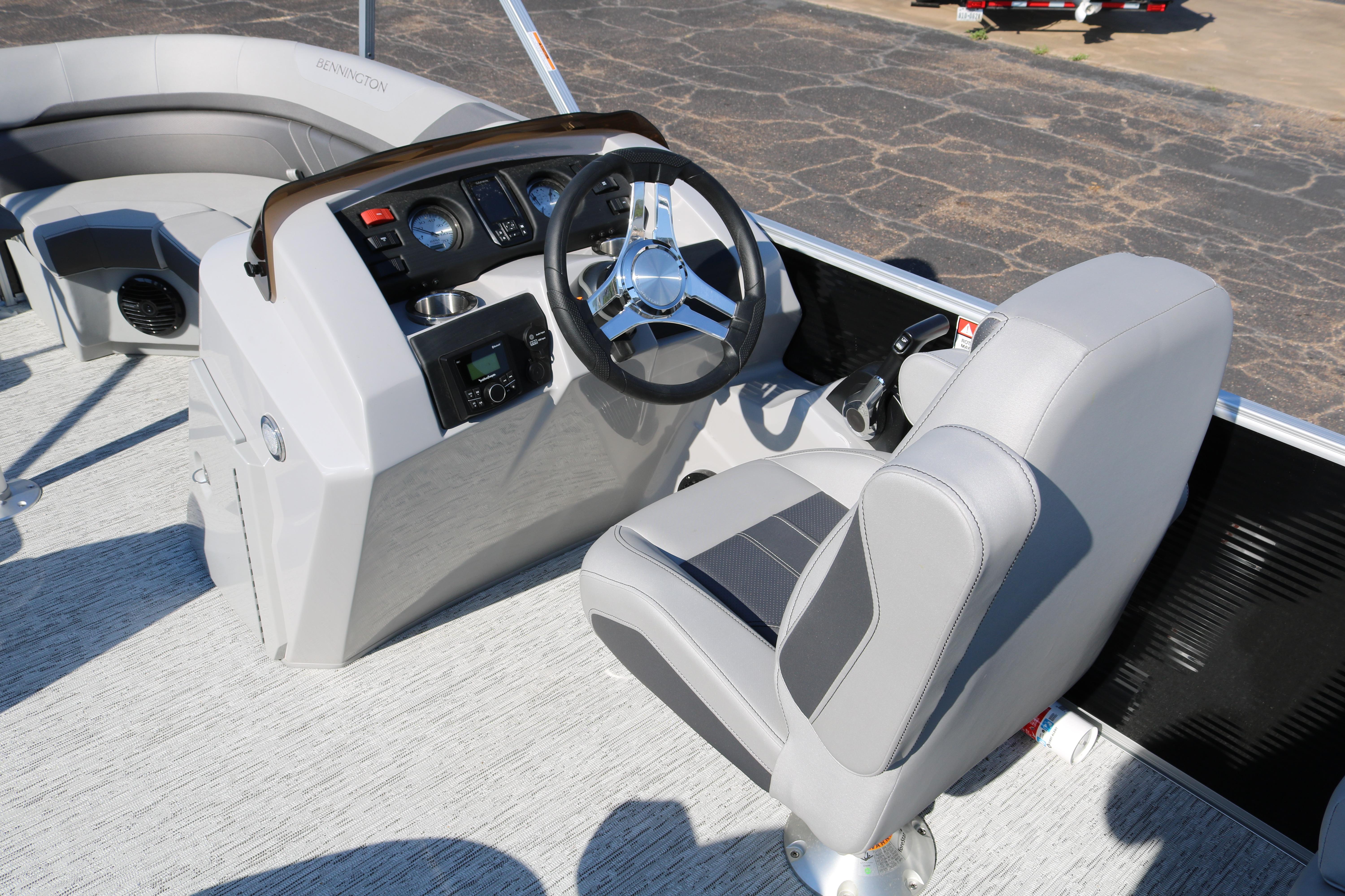 2026 Bennington 22SX Stern Radius boat interior with steering wheel and seating.