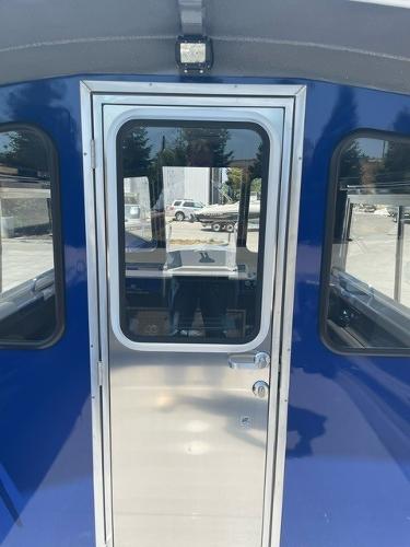 2025 Spartan 240 Maximus Pro, blue exterior, featuring a sleek metal door with windows.