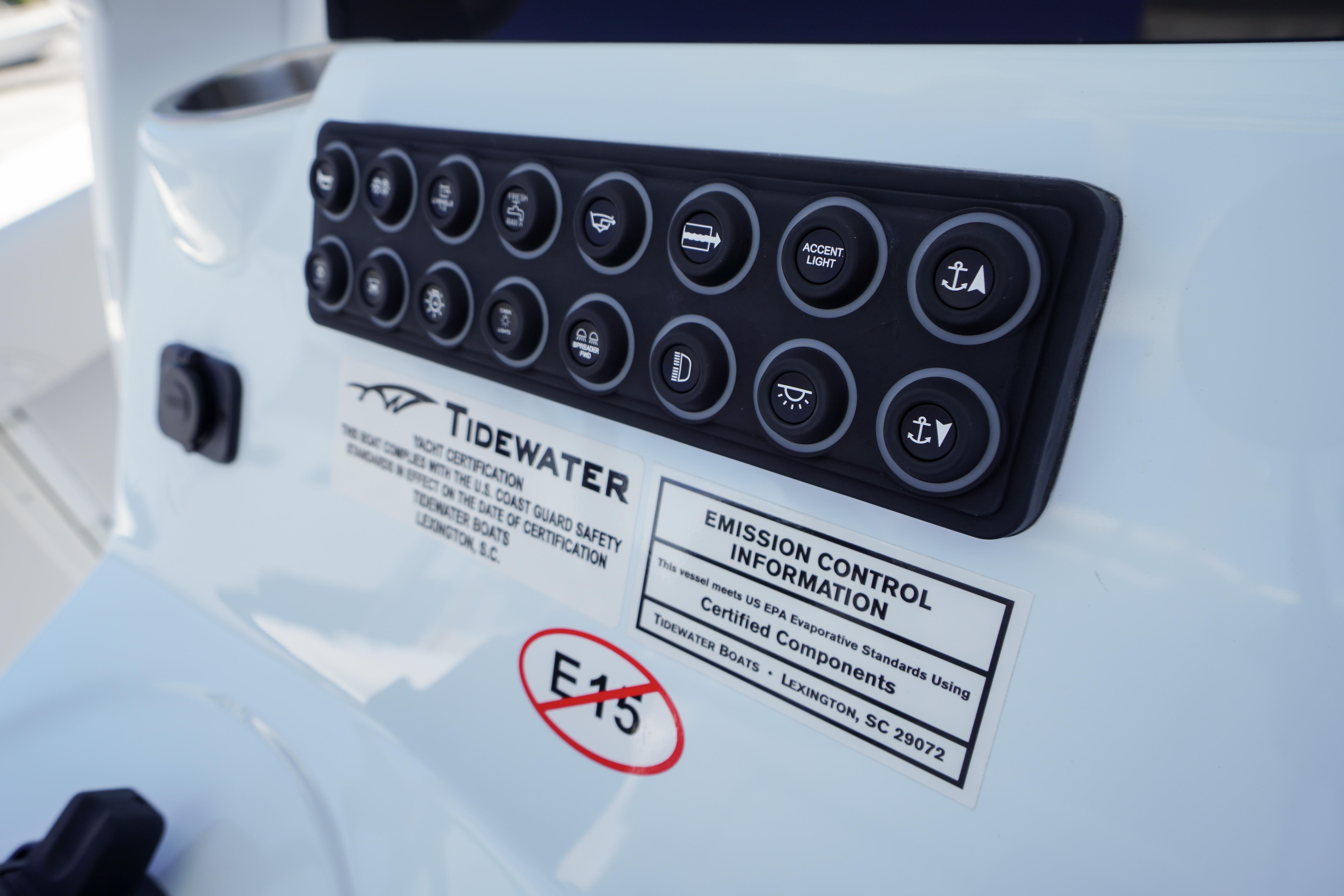 Control panel of 2026 Tidewater 302 CC Adventure boat with labeled buttons and emission information.