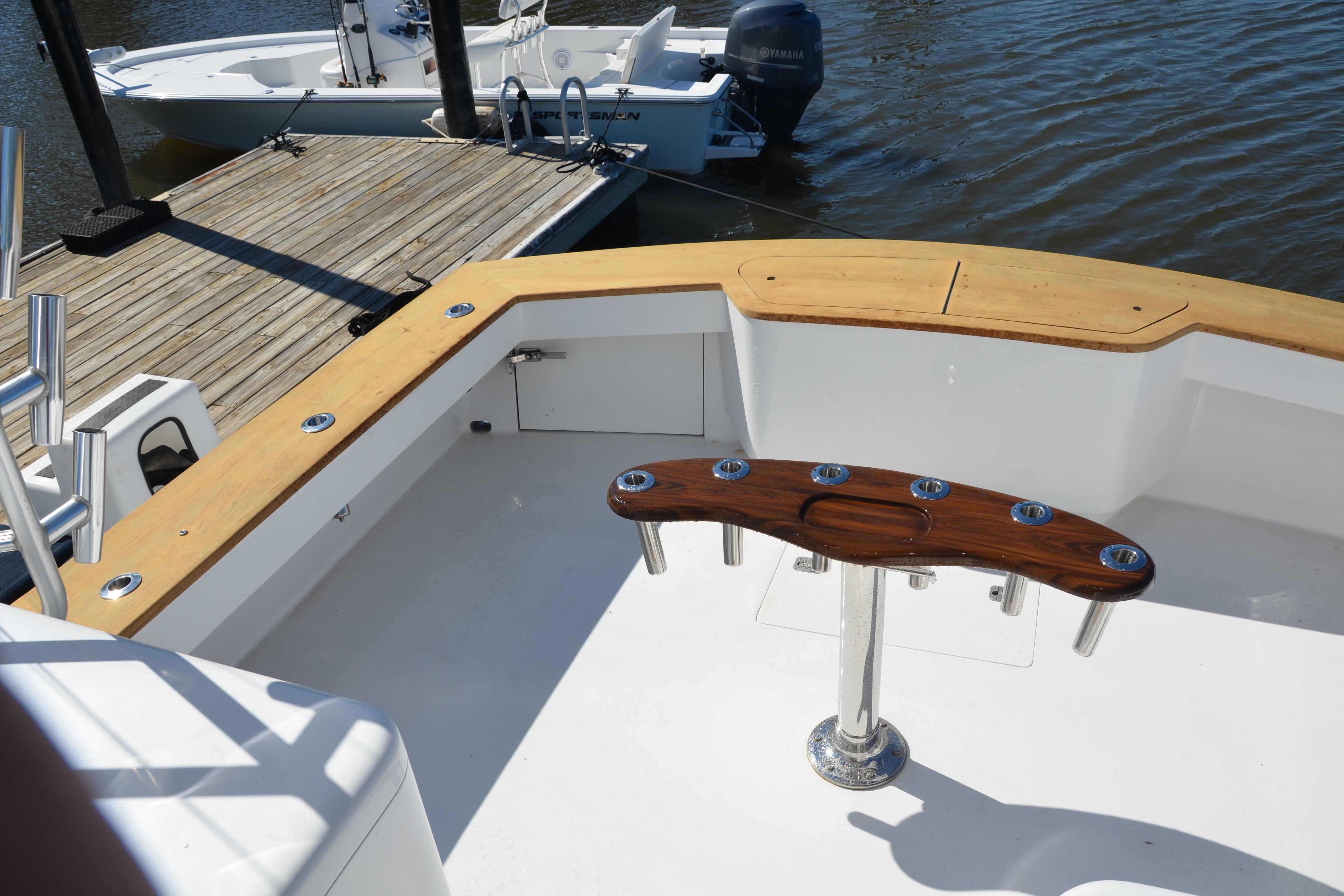 2006 Custom Carolina Heritage Express boat deck with wooden trim and rod holders.