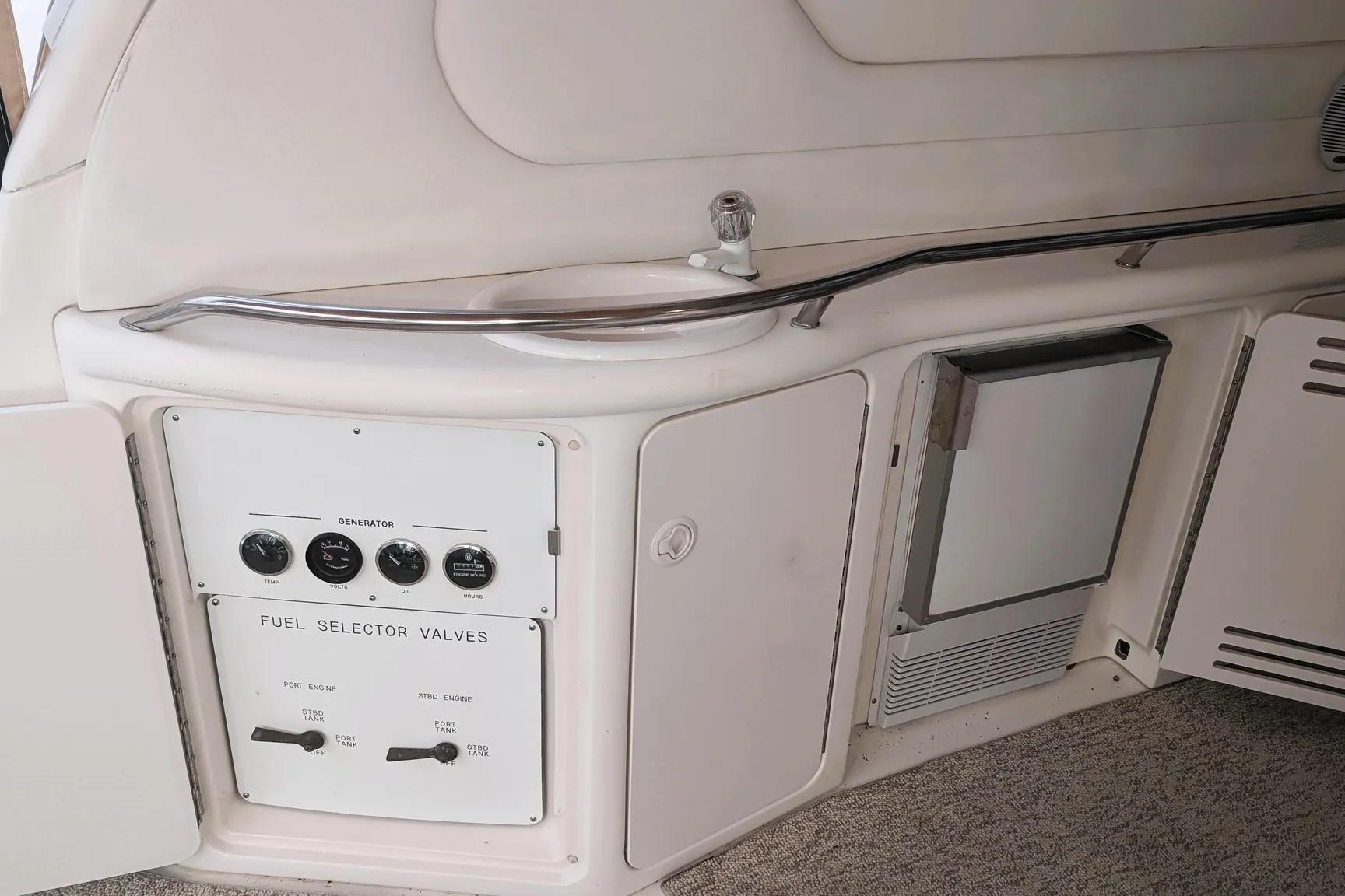Control panel and storage area on a 2000 Sea Ray 380 Sundancer boat.
