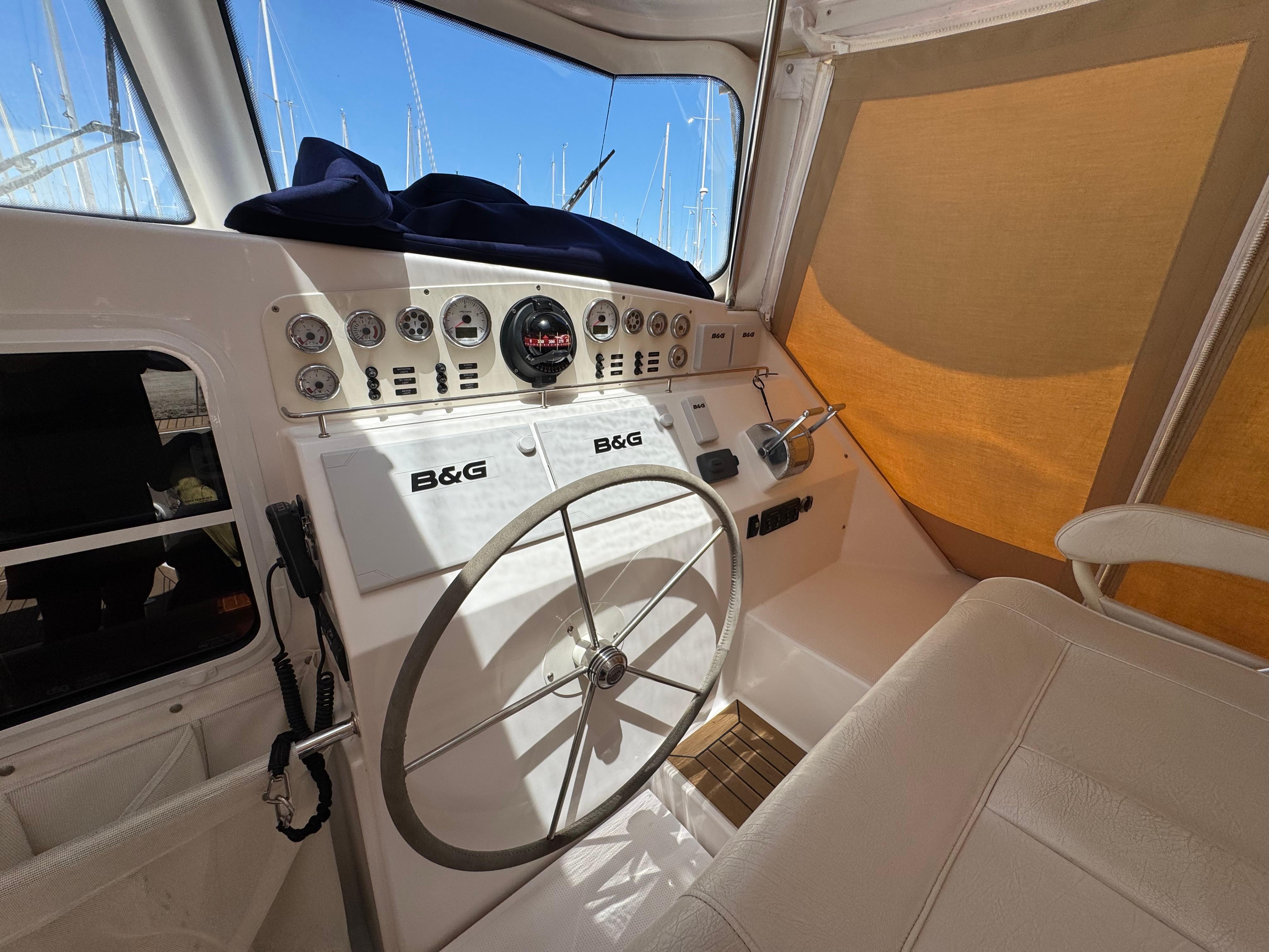 Cockpit of 2016 Antares 44 yacht with steering wheel and navigation instruments.