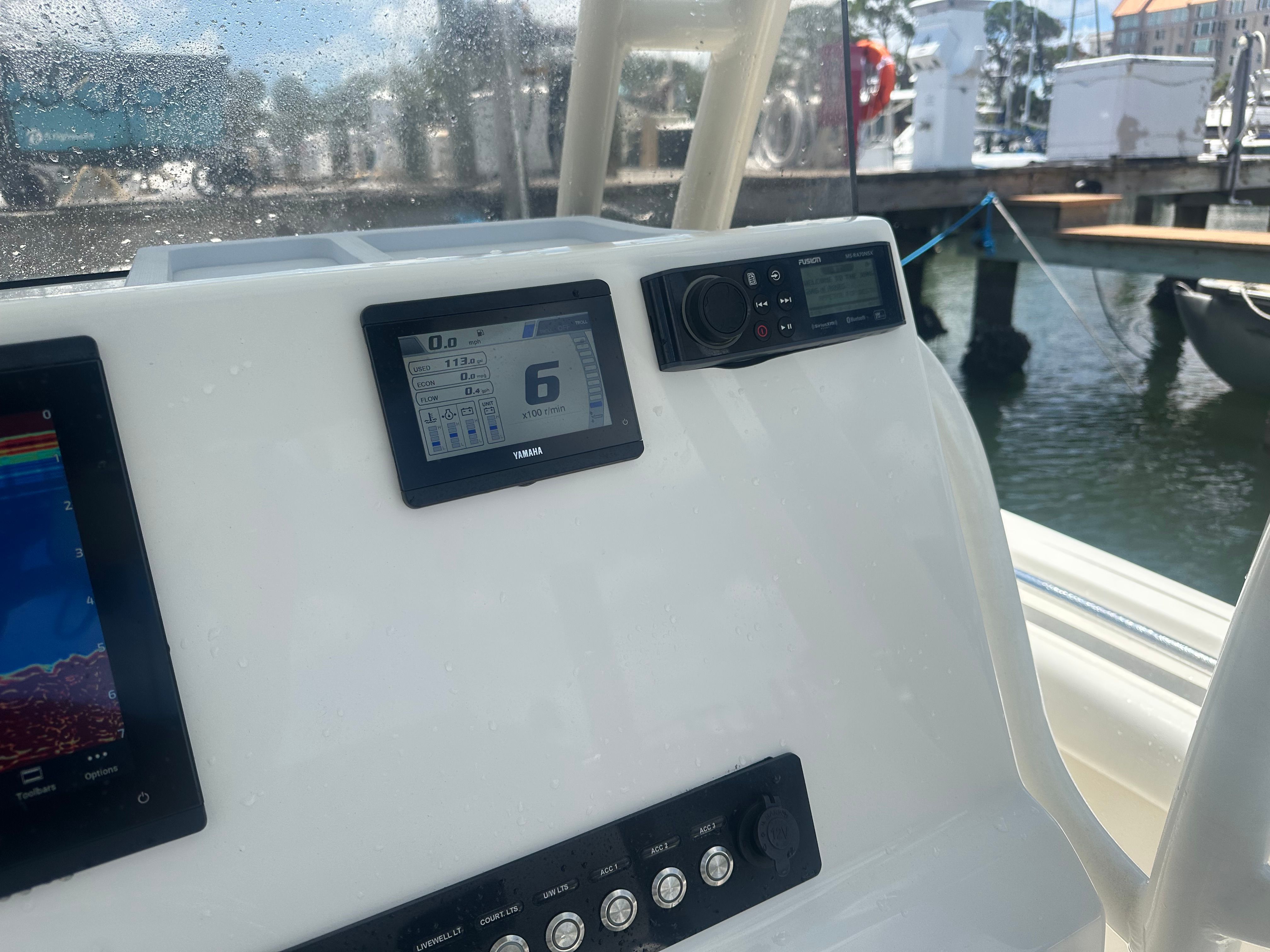 The cockpit of a Key West 219 FS boat with modern instruments.