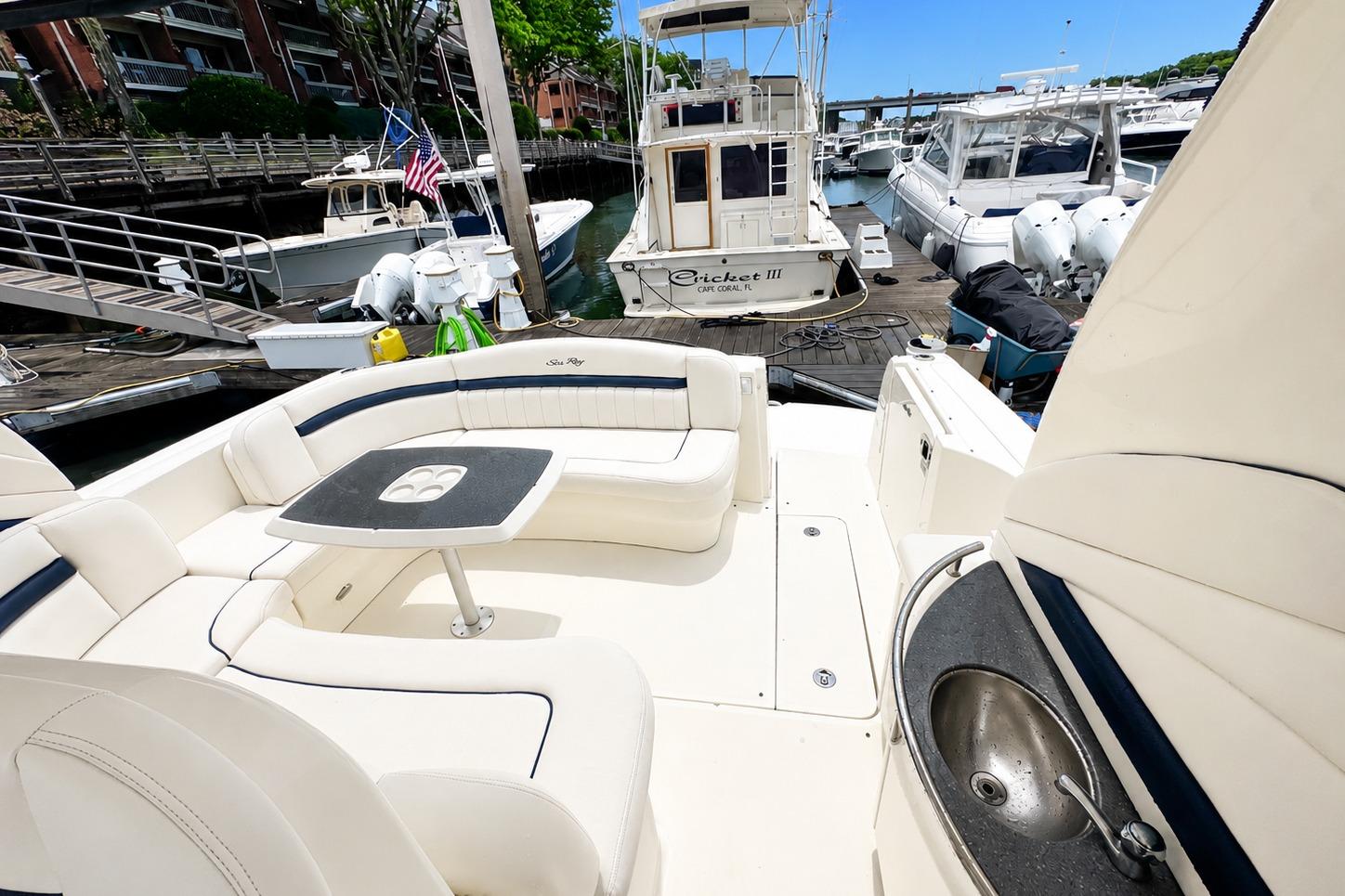 2006 Sea Ray 40 Sundancer yacht with spacious seating and docked at marina.