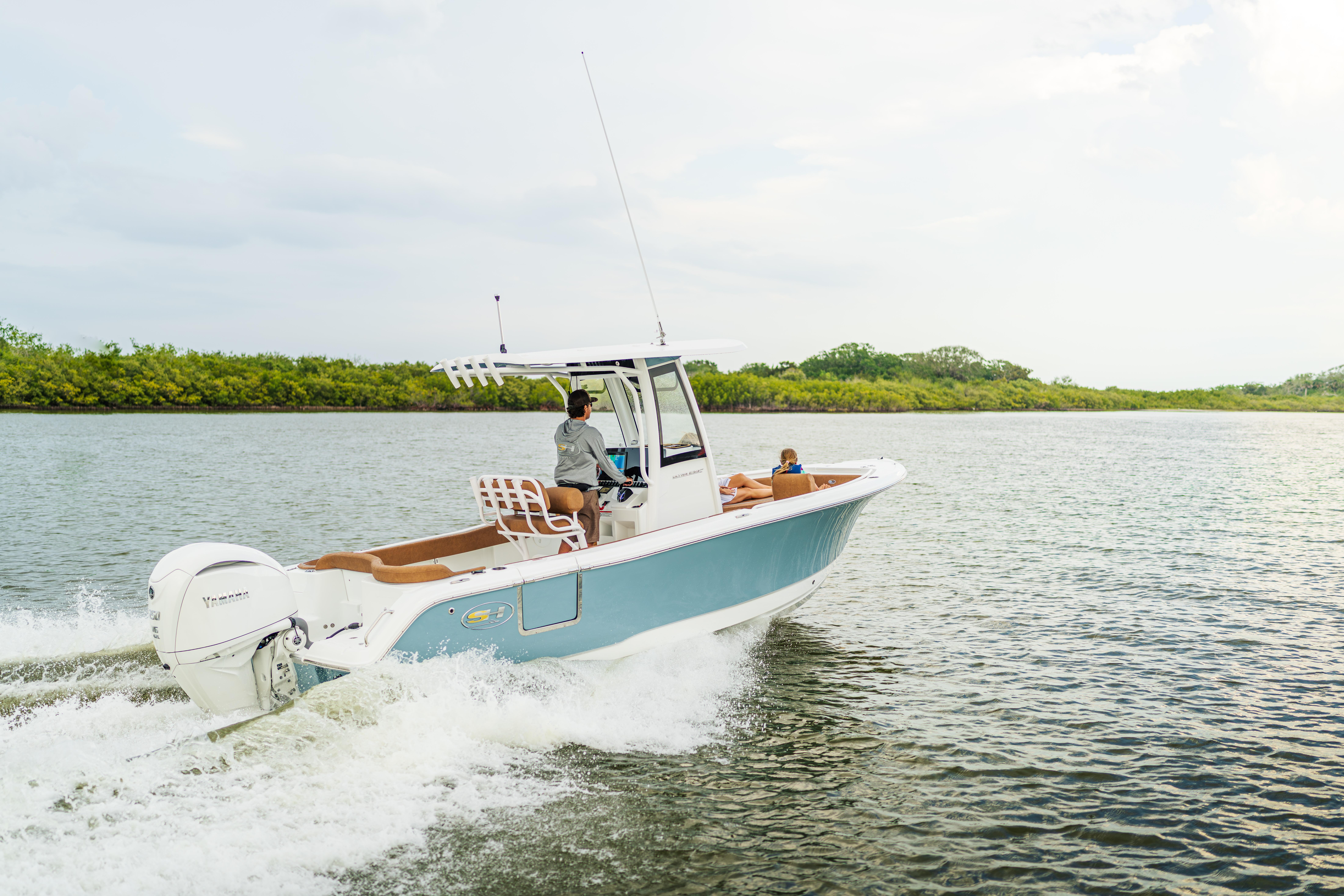 2026 Sea Hunt Ultra 235 SE boat cruising on a calm river.