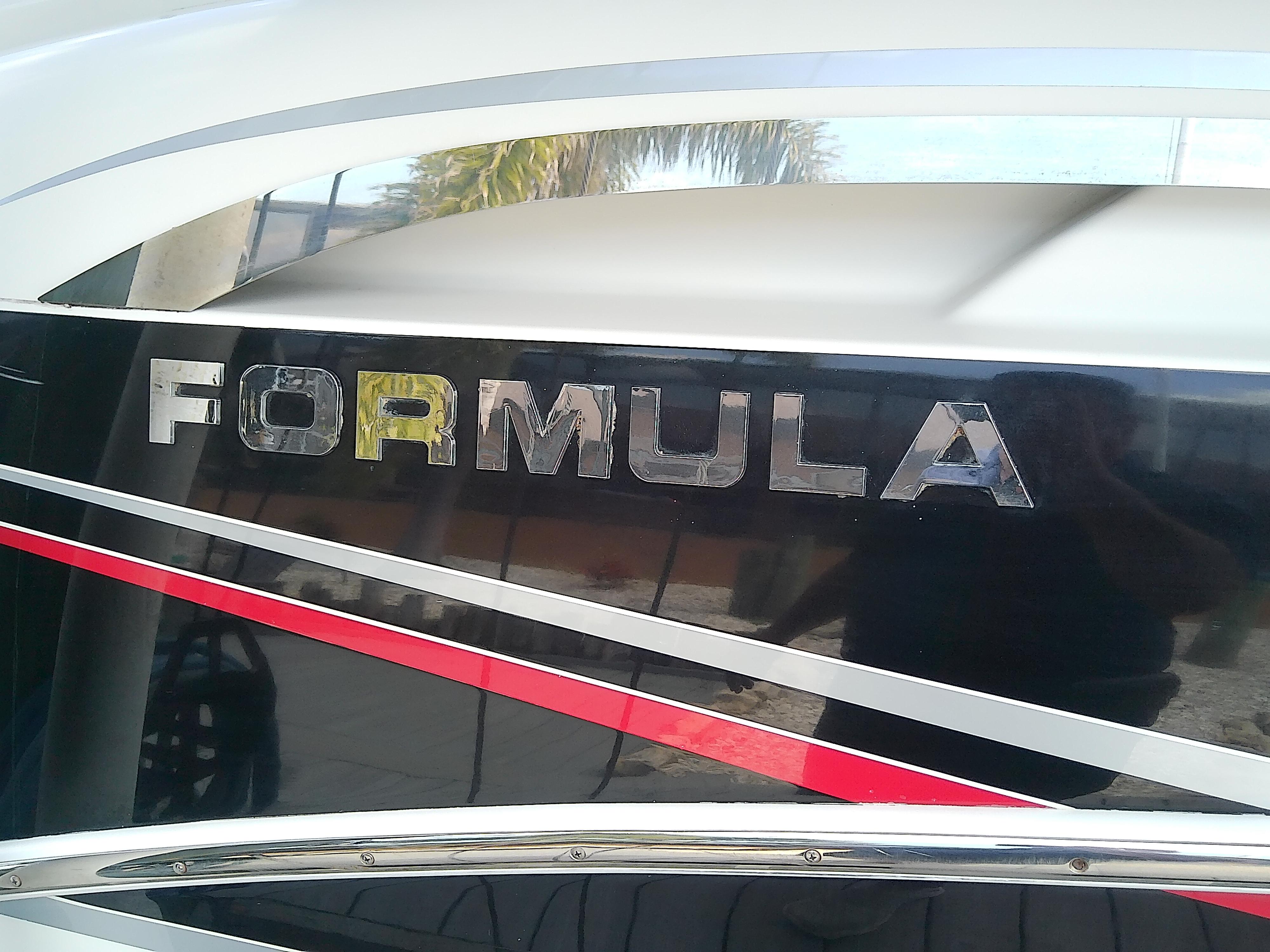 2008 Formula 310 Sun Sport boat with sleek black and red design.