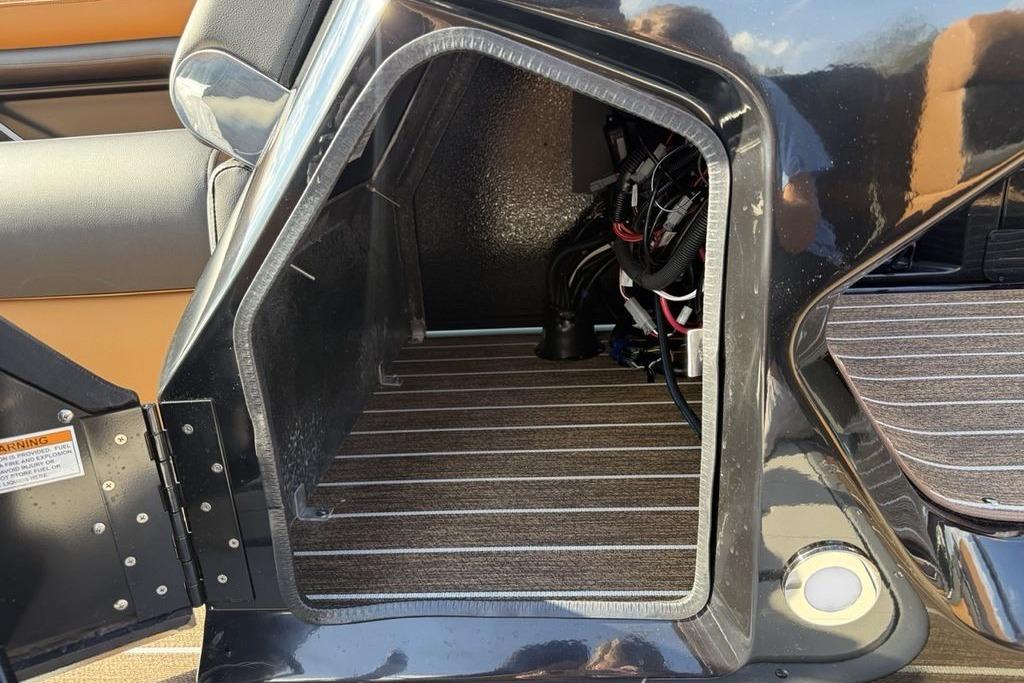 Open storage compartment in 2026 Premier 250 Solaris RS CL boat, showing interior wiring.