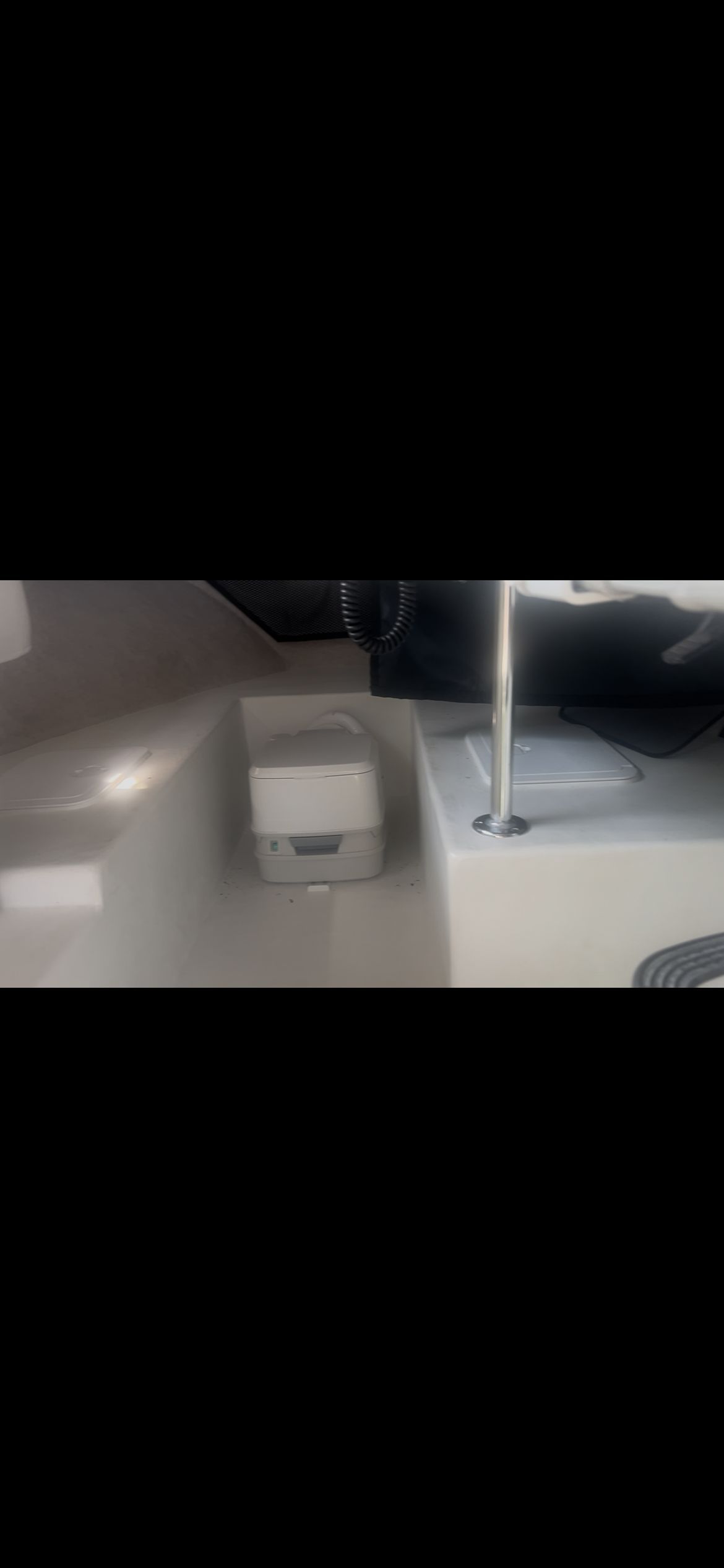 Interior of a Parker 2320 Sport Cabin boat with seating and helm.