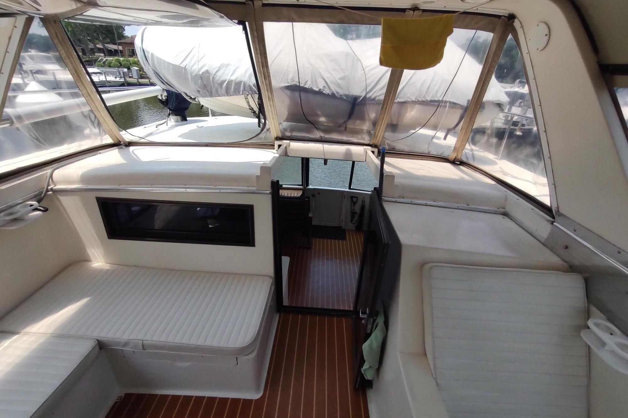 1989 Hyatt Double Cabin Motoryacht interior with seating and clear canopy.