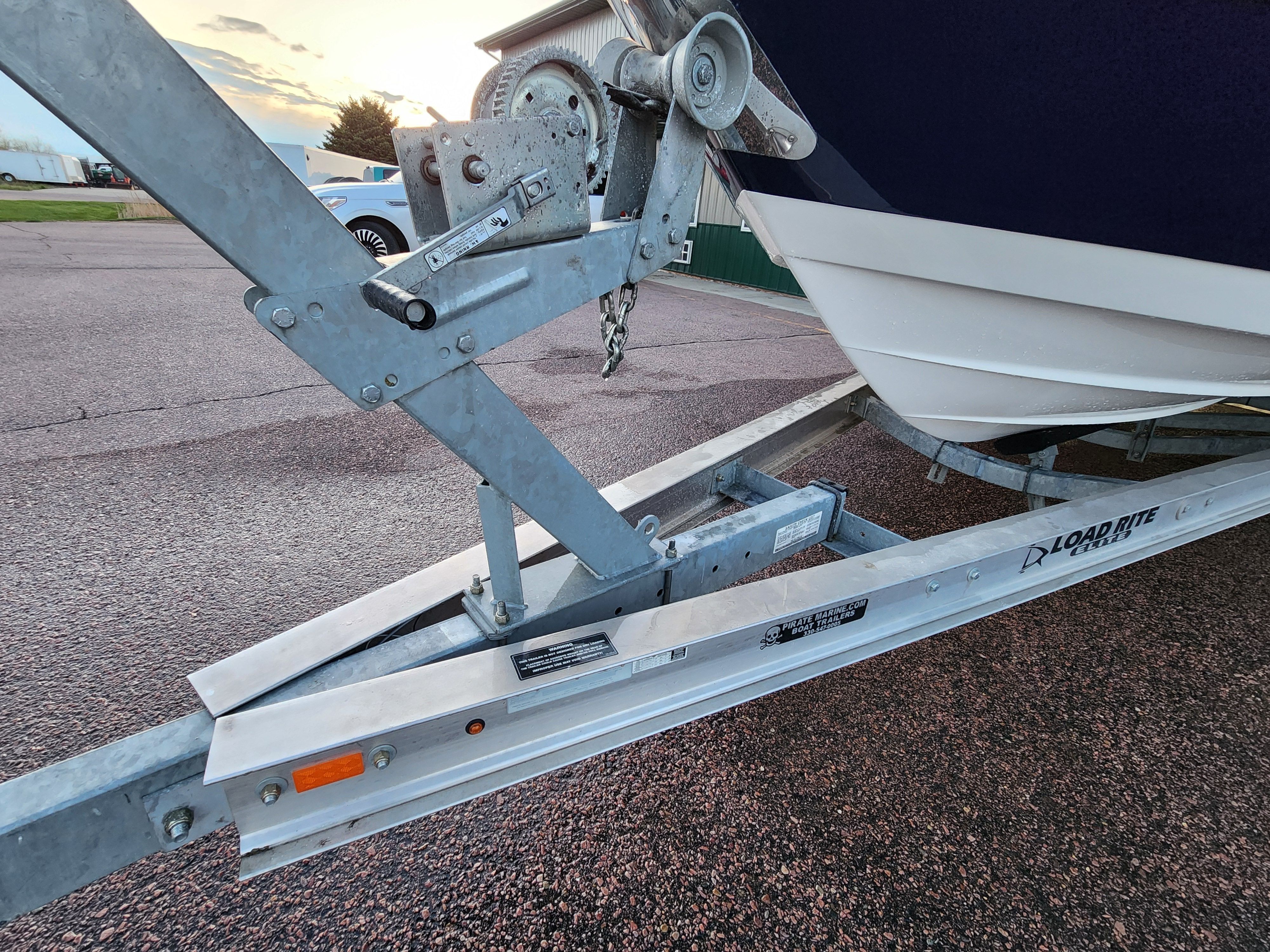 Boat trailer with 2015 Monterey 268SSC on asphalt surface.