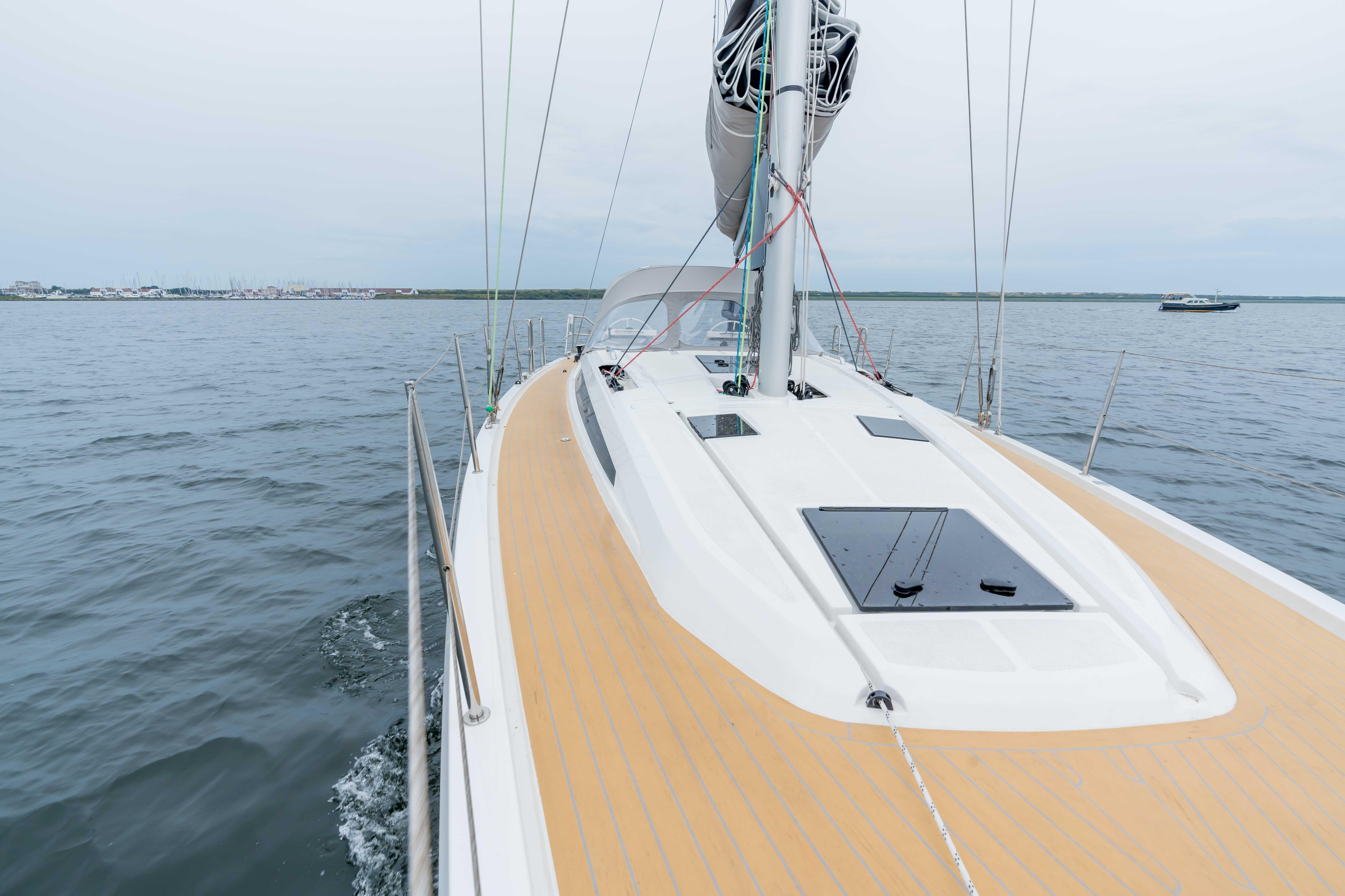 Italia Yachts 12.98 (2023) sailing on calm waters, showcasing sleek deck design.