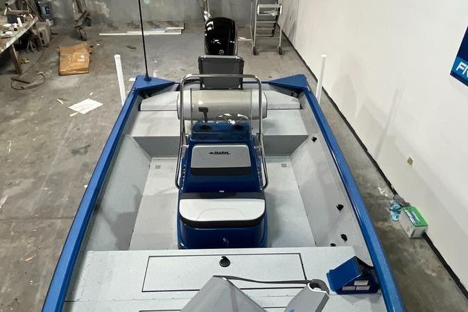 2025 SeaArk Shadow 187T boat interior with blue accents in a workshop setting.