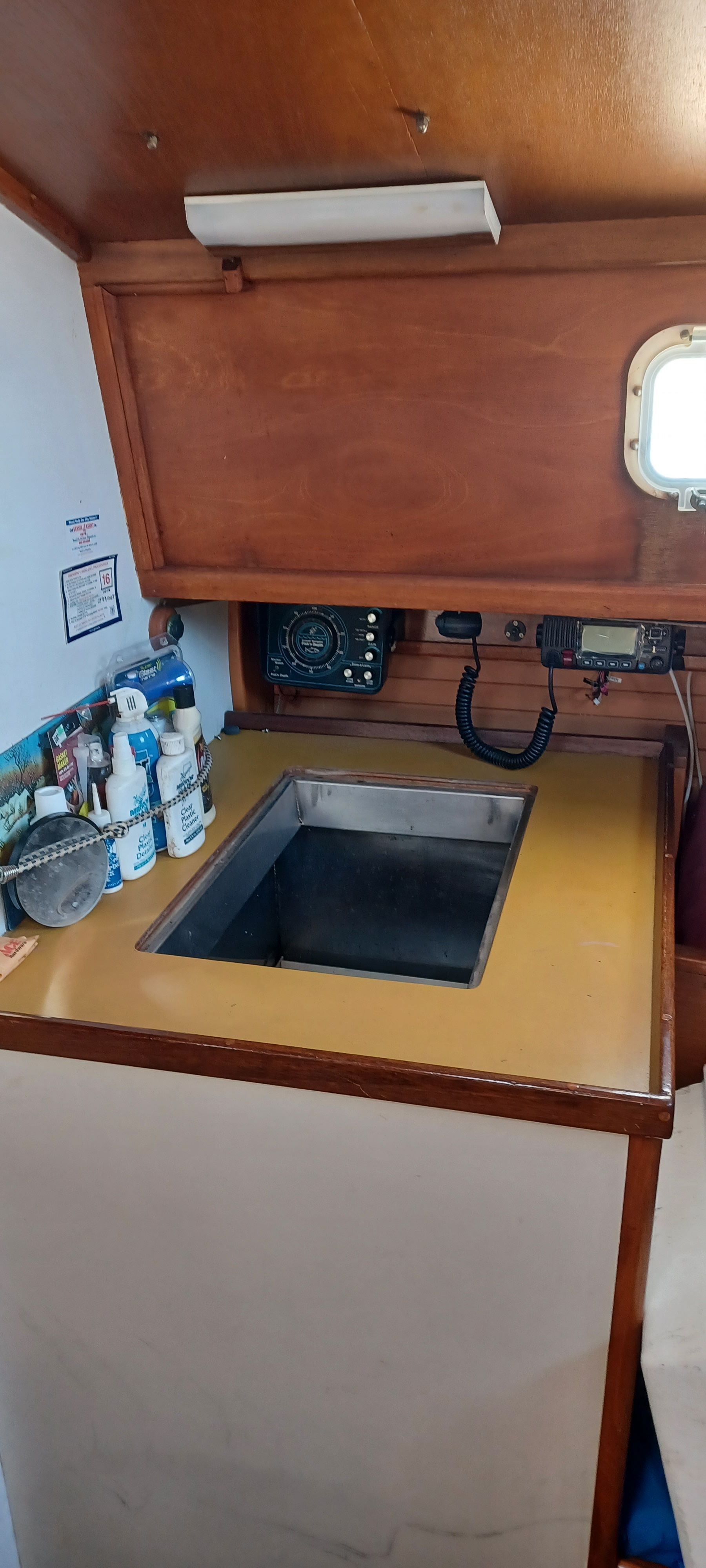 Interior of a boat with a sink and communication devices.