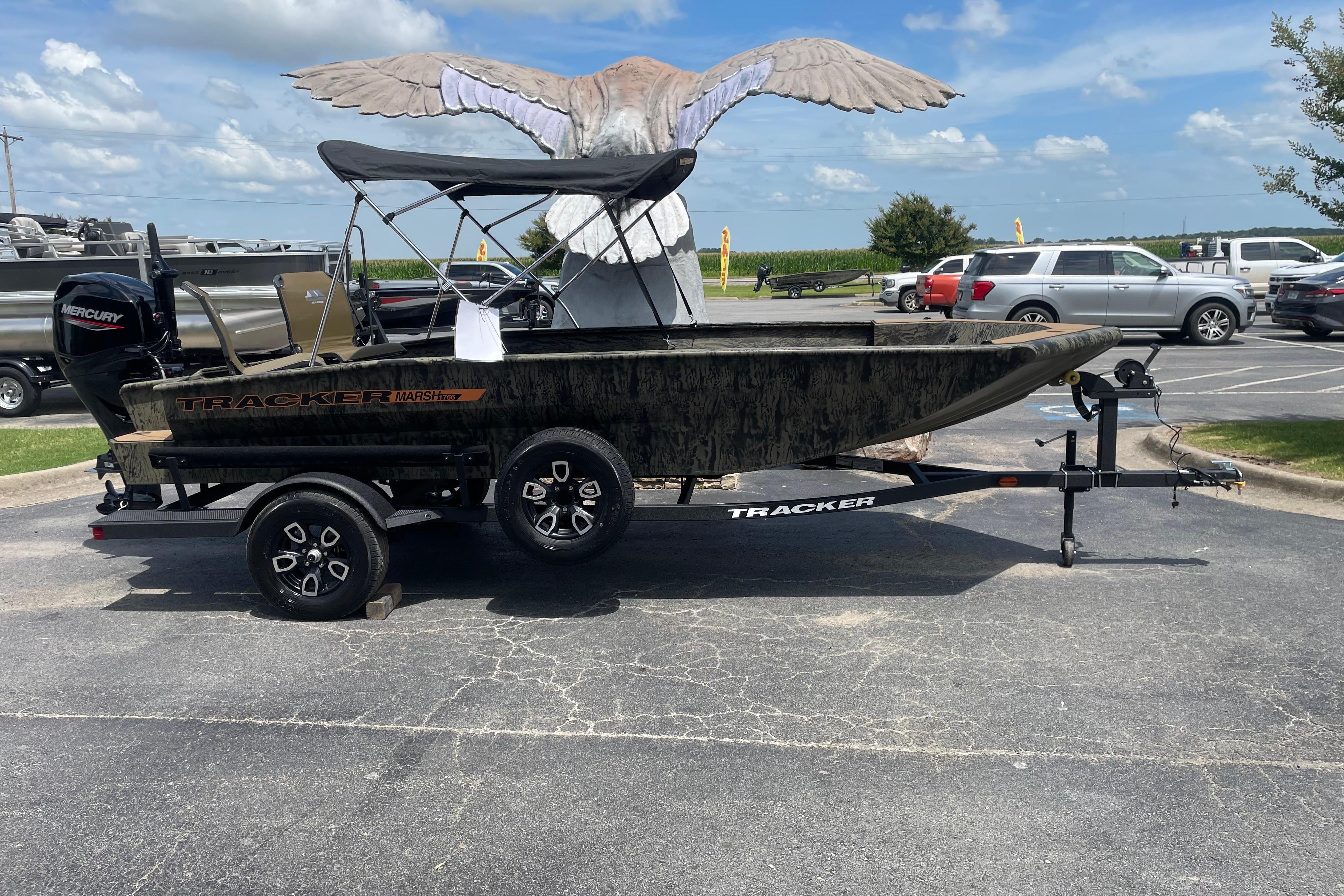 2026 Tracker Grizzly 1756 T Marsh boat on trailer in parking lot.