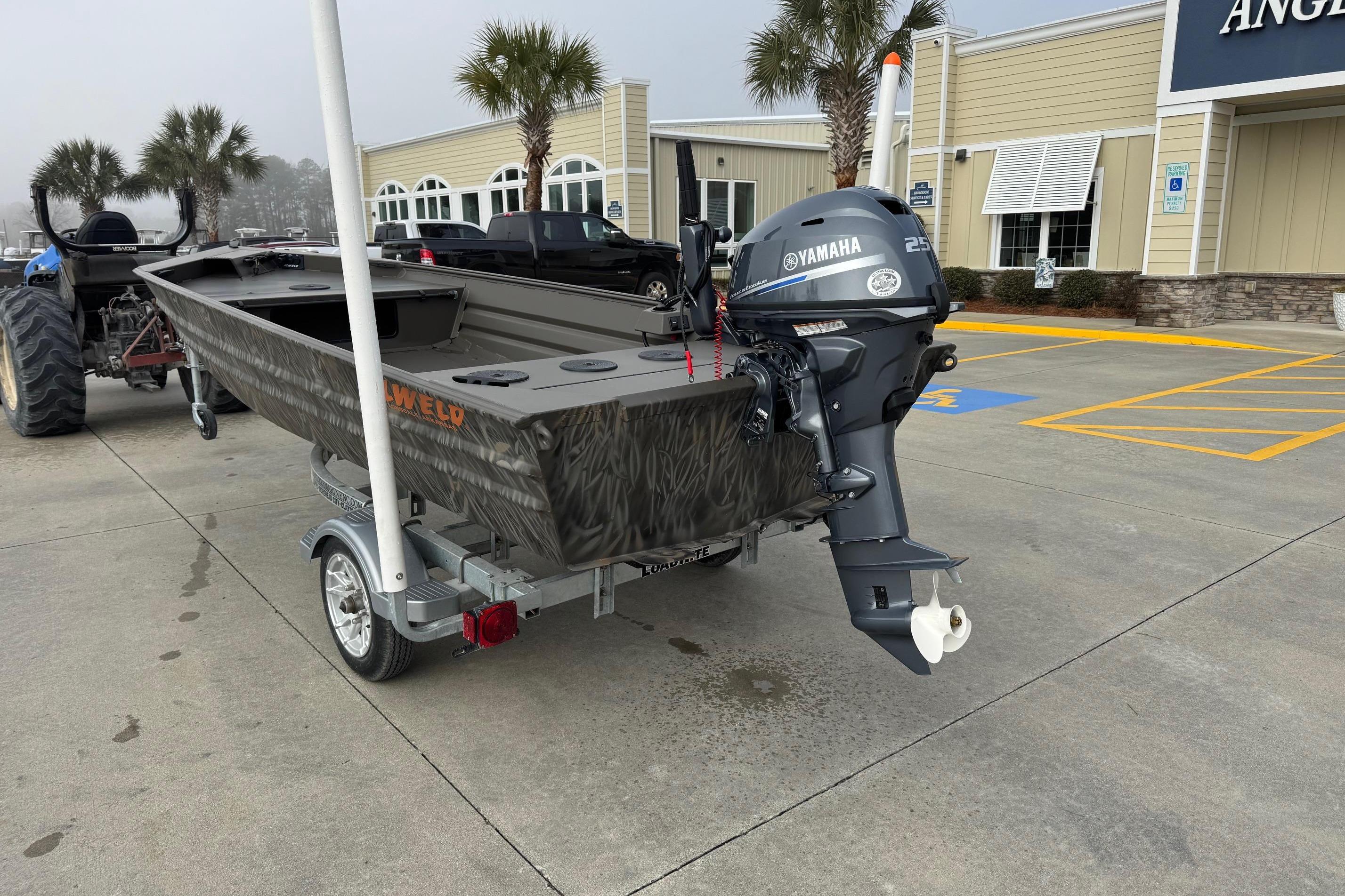 2026 Alweld 1548VV Marsh boat with Yamaha motor on trailer, parked outside a building.