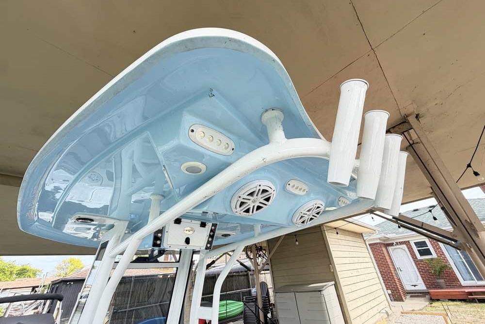 2024 Tidewater 232 LXF boat's blue T-top with rod holders and speakers.