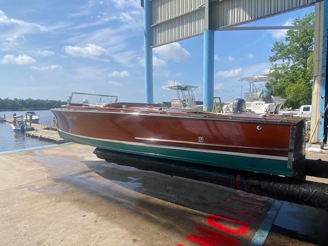 2000 Grand Craft Classic Runabout boat on a dock under a blue sky.