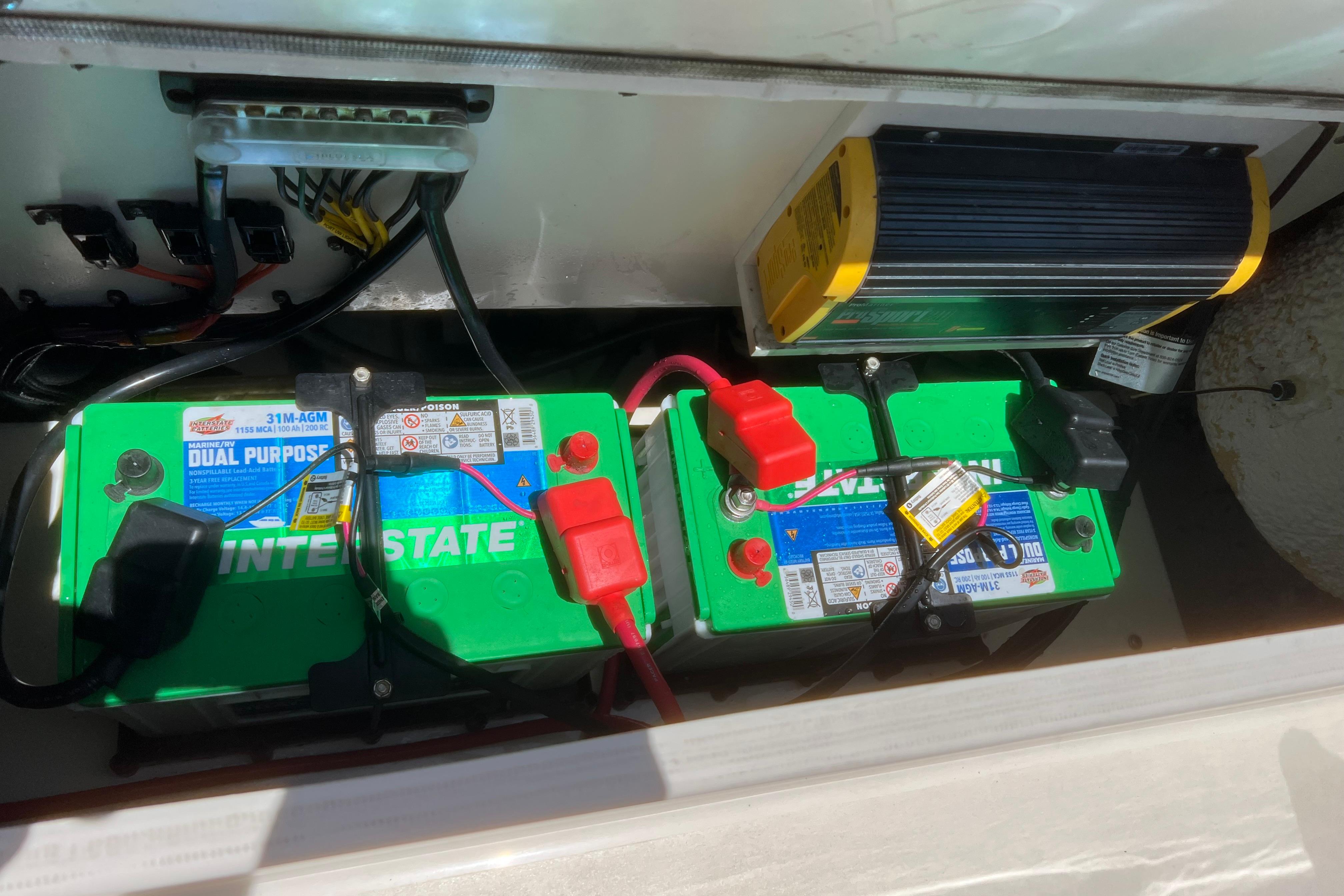 Battery compartment of a 2018 Cobia 201 Center Console boat with dual Interstate batteries.