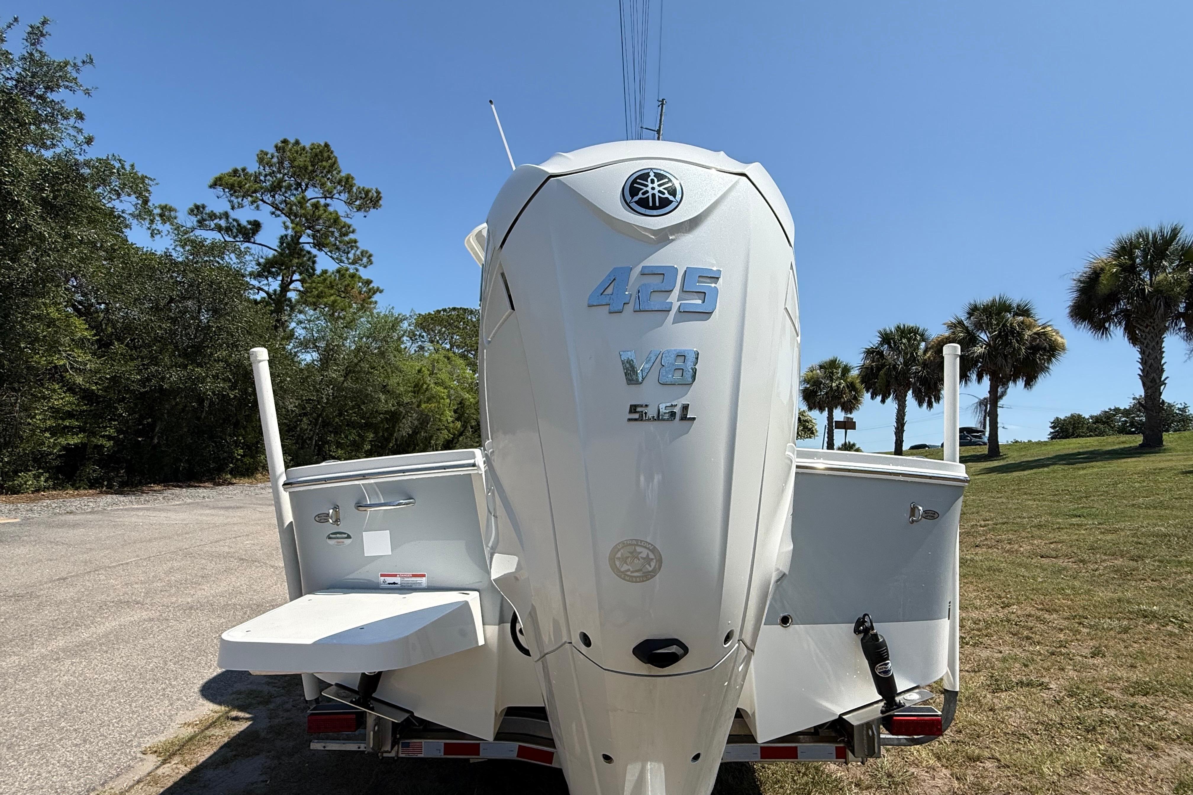 2023 Regulator 26XO boat with Yamaha 425 V8 engine, parked outdoors.