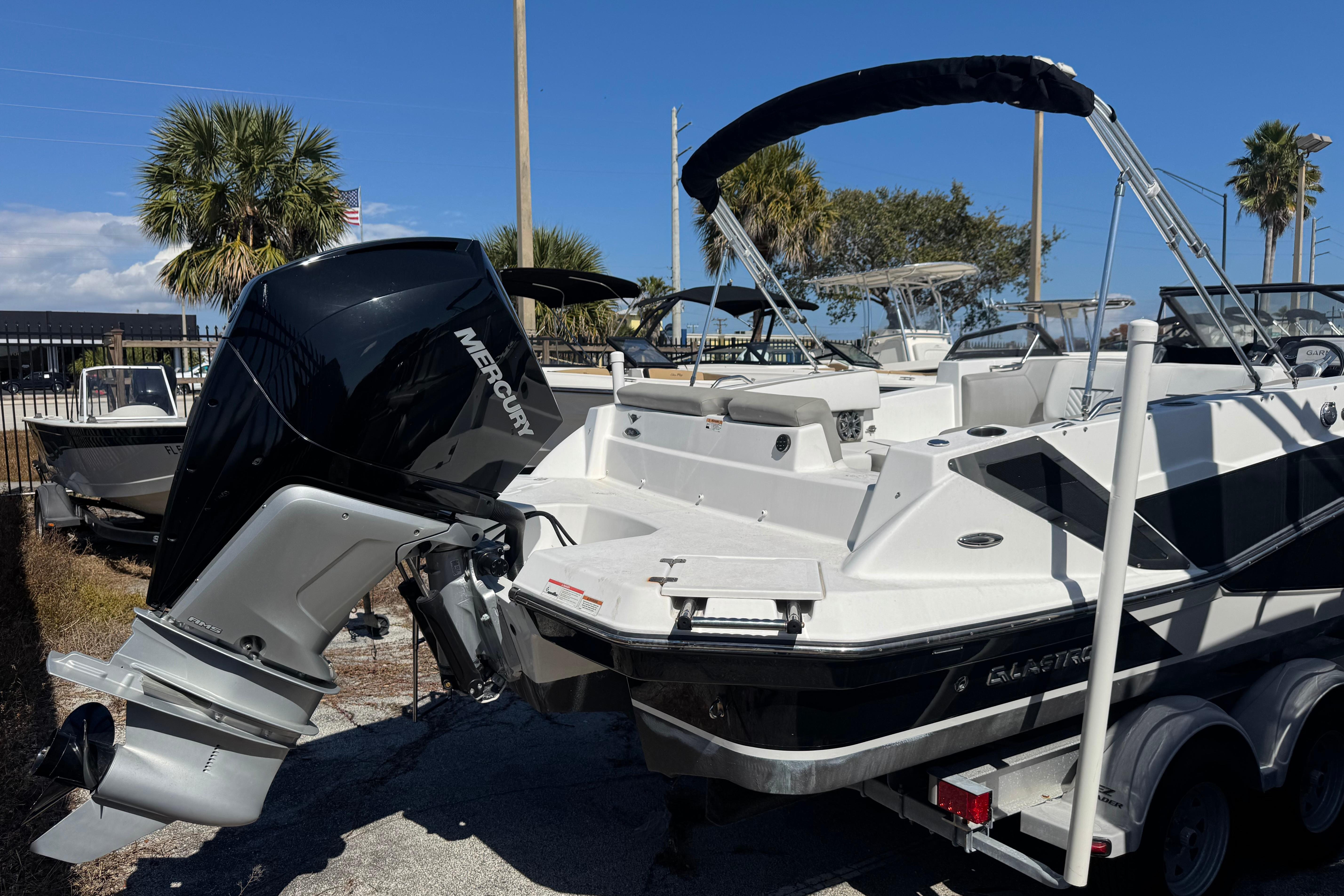 2020 Glastron GTD 240 boat with Mercury outboard motor, parked outdoors.