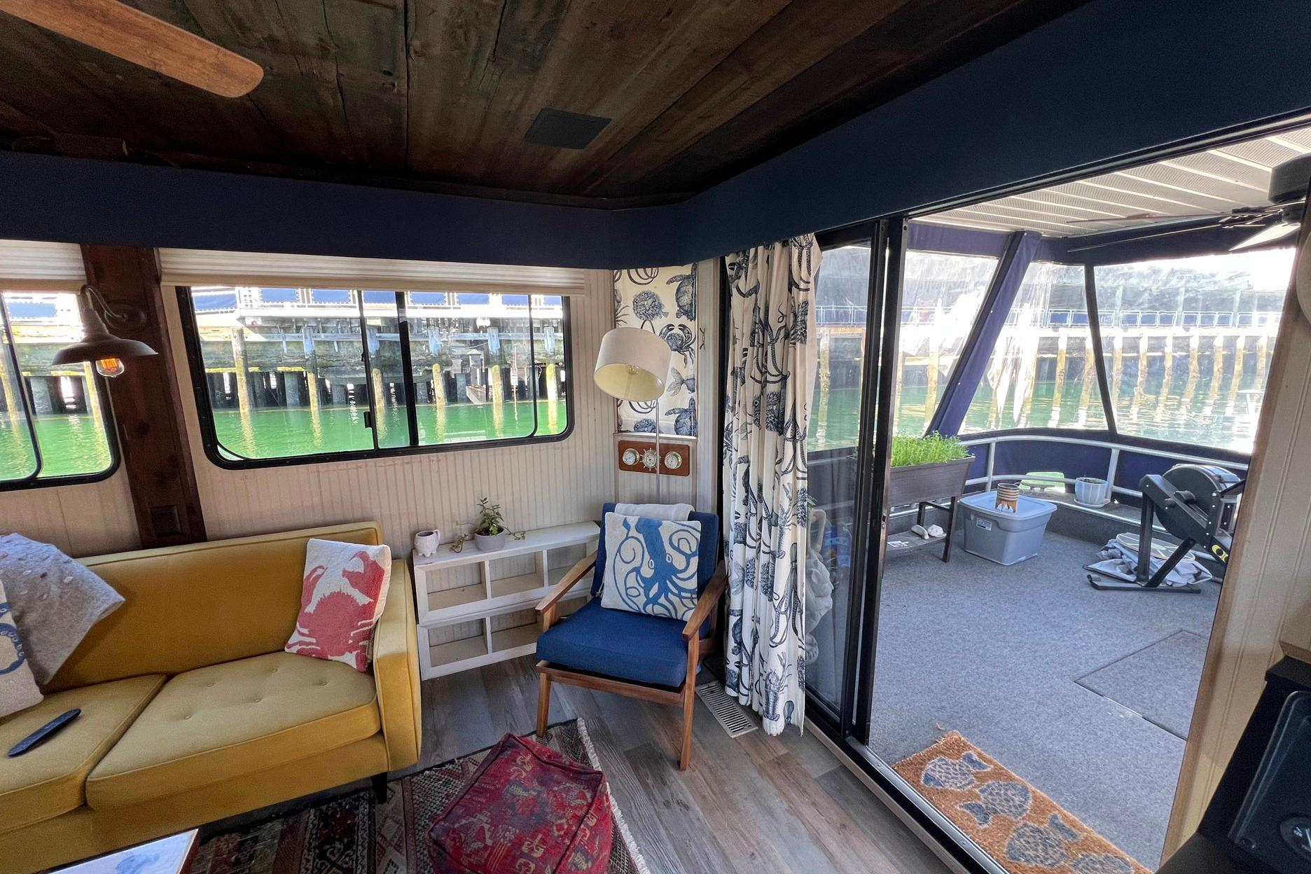 Interior of a 1993 Sumerset houseboat with cozy seating and waterfront view.