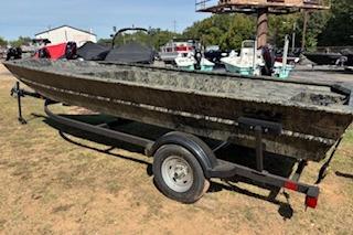 2026 Tracker Grizzly 1860 Utility boat on trailer, parked outdoors.