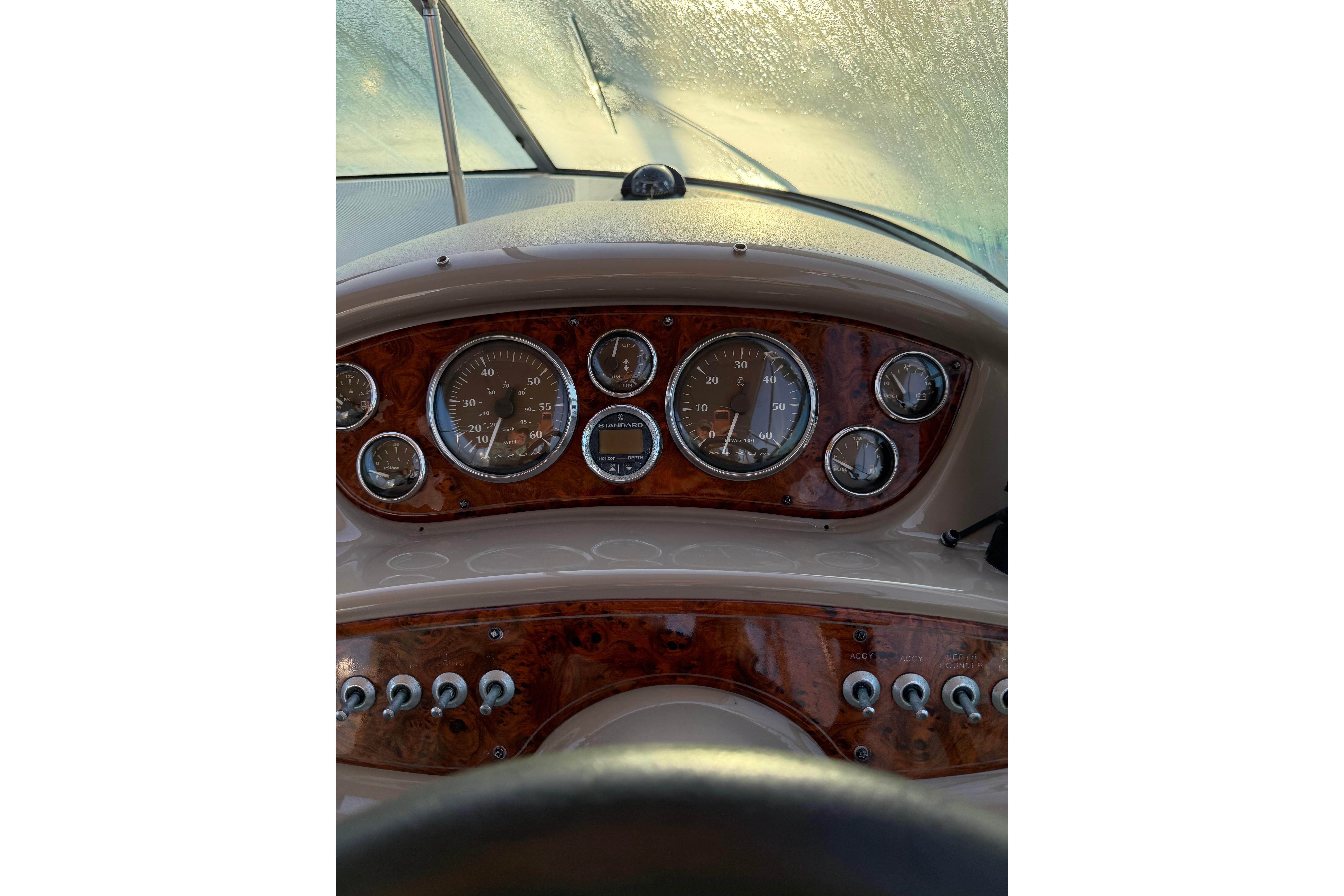 Dashboard of a 2001 Maxum 2800 SCR boat with gauges and controls.