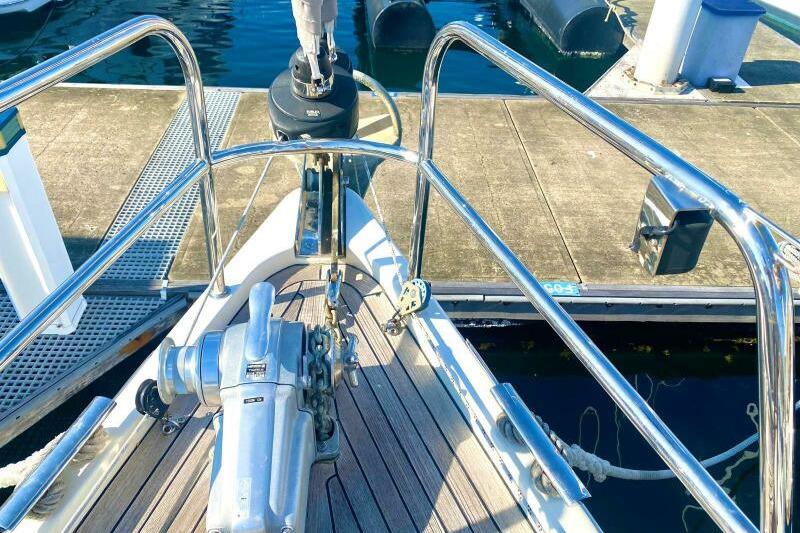 Bow of 2009 Southerly 49 yacht with anchor and polished railings at dock.