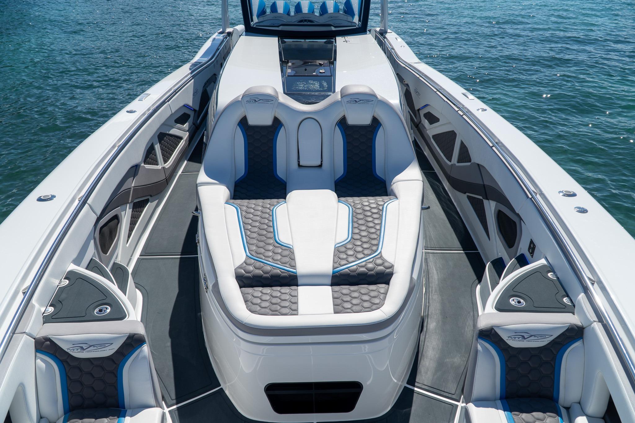 Luxurious 2023 MTI 50v boat interior with sleek seating and modern design on the water.