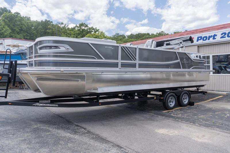 2026 SunCatcher Elite 326 SL pontoon boat on trailer, parked outdoors.