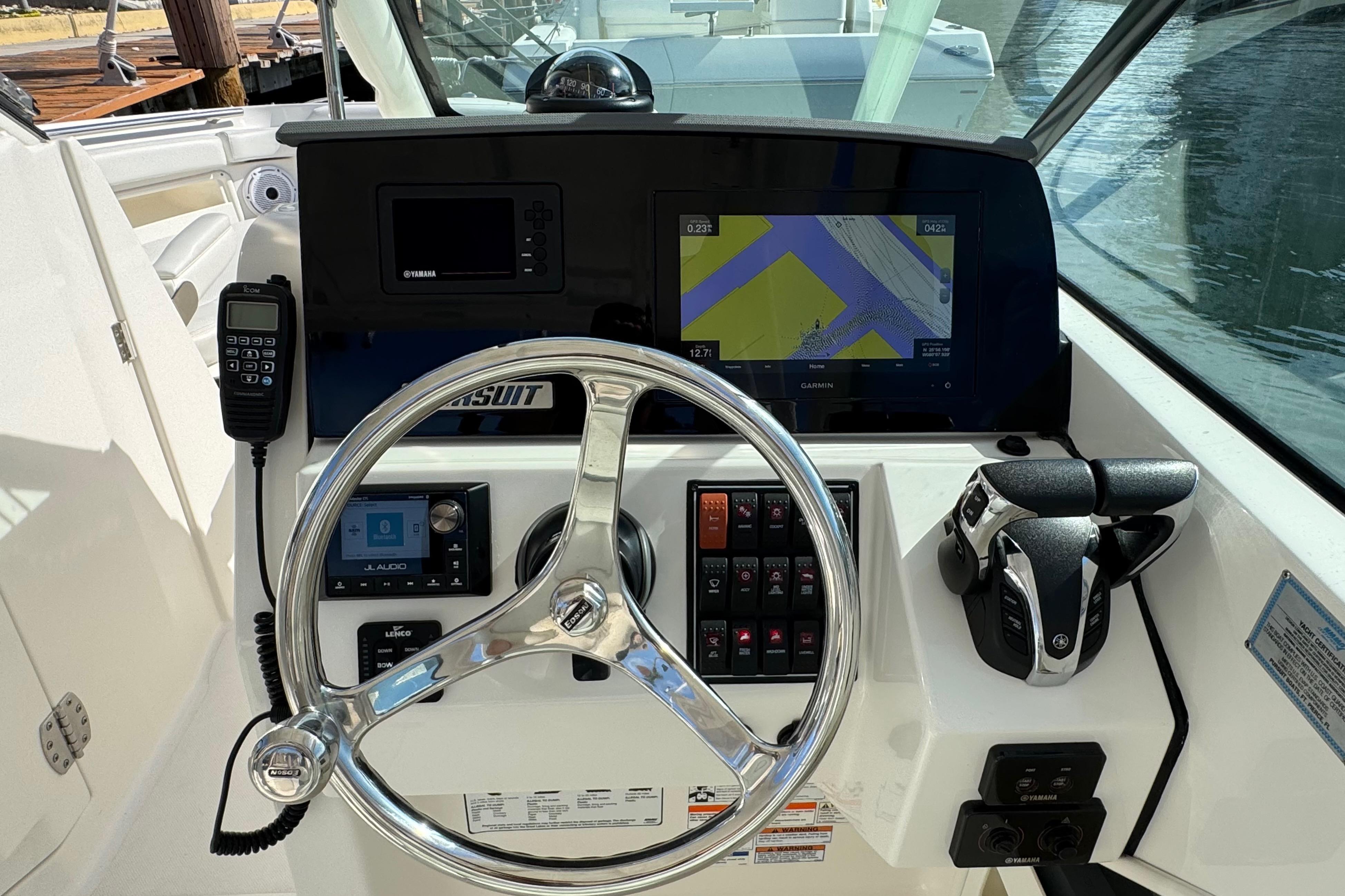 2022 Pursuit DC 266 Dual Console boat dashboard with steering wheel and navigation controls.