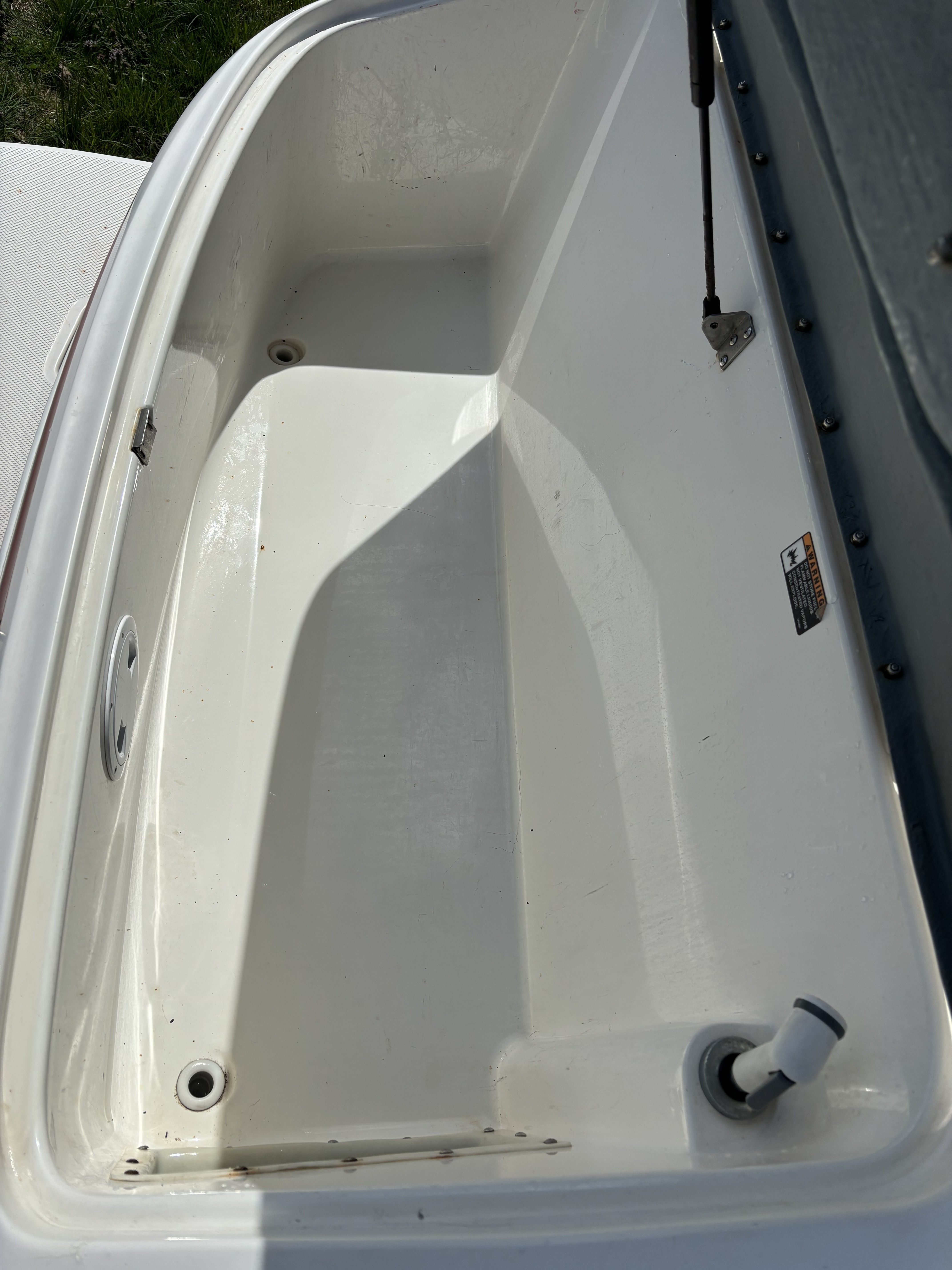Interior of a 2005 Maxum 2400 SC3 boat, empty storage compartment.