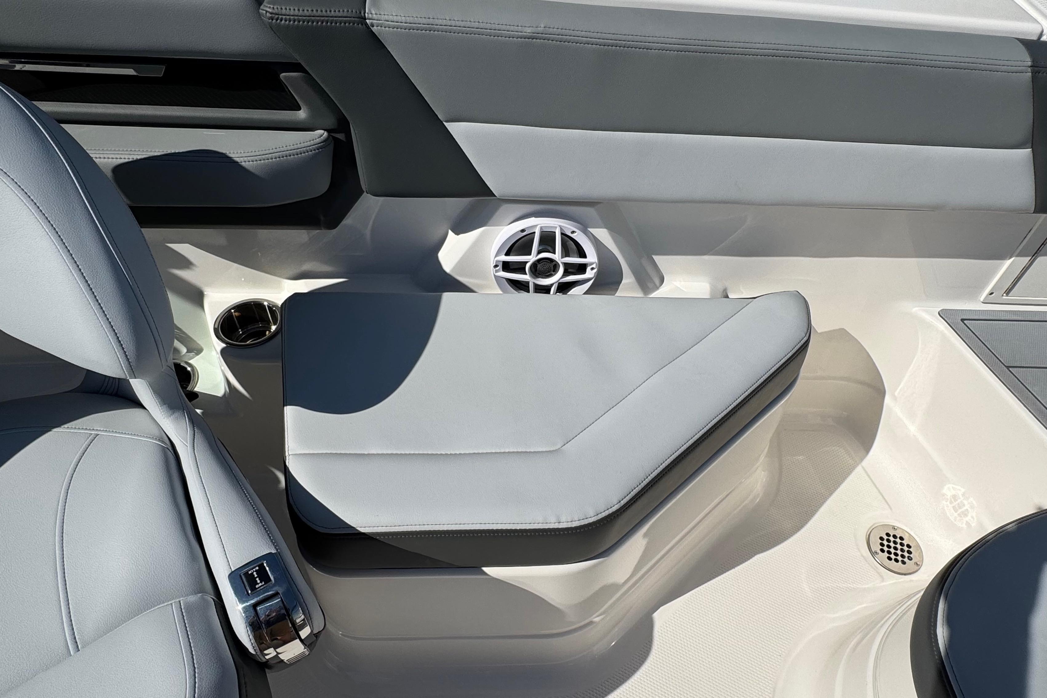 Interior seating of 2026 Chaparral SSX 4 boat with speaker and cup holder.