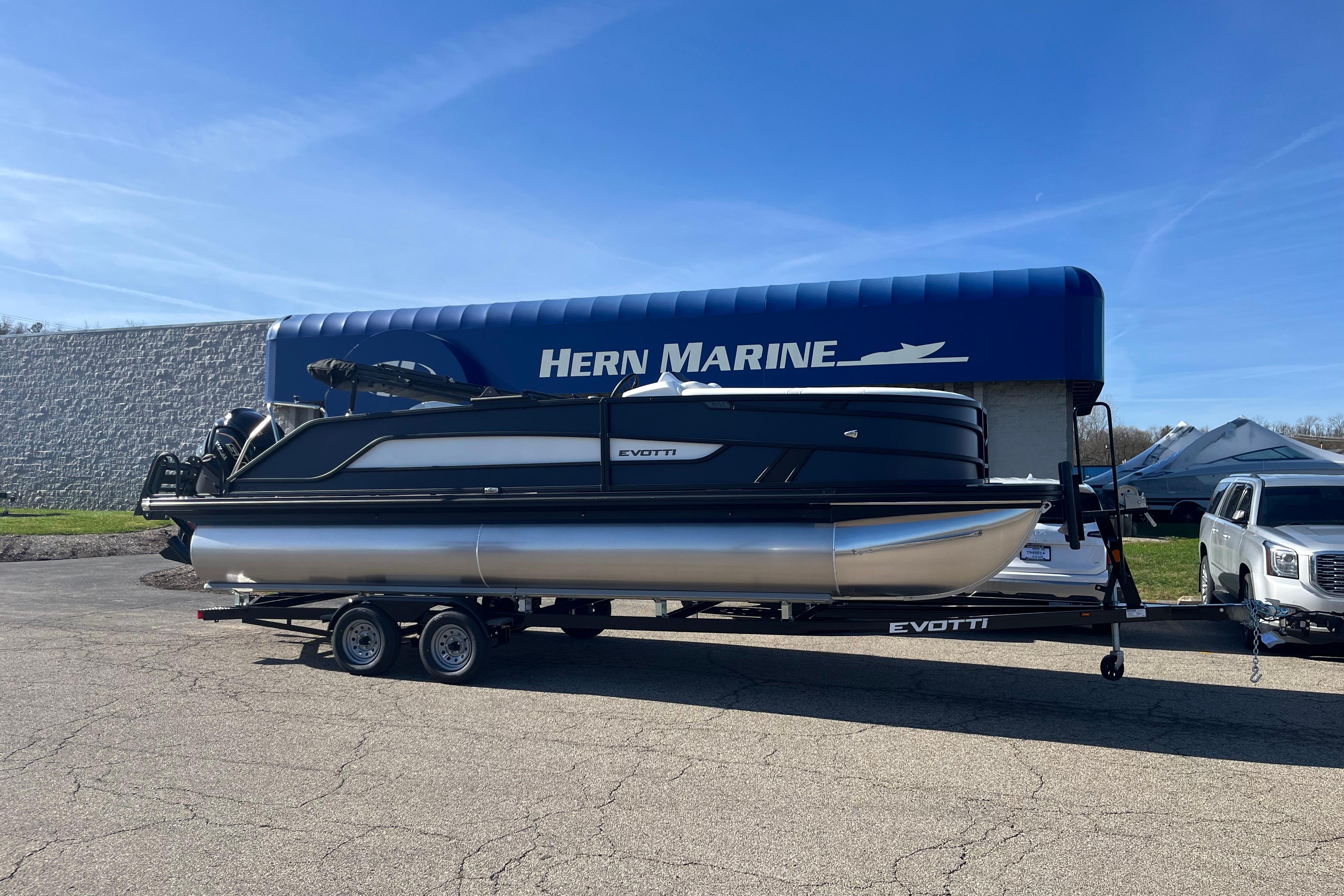 2026 Evotti 523CS pontoon boat on trailer at Hern Marine dealership.