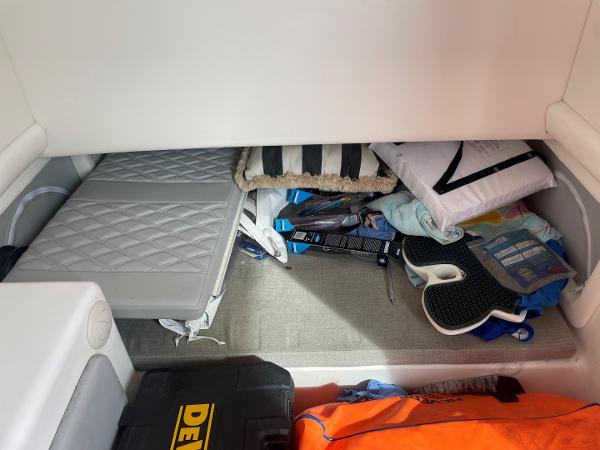 Storage compartment in a 2020 Front Runner 39 Center Console boat, with various items and equipment.