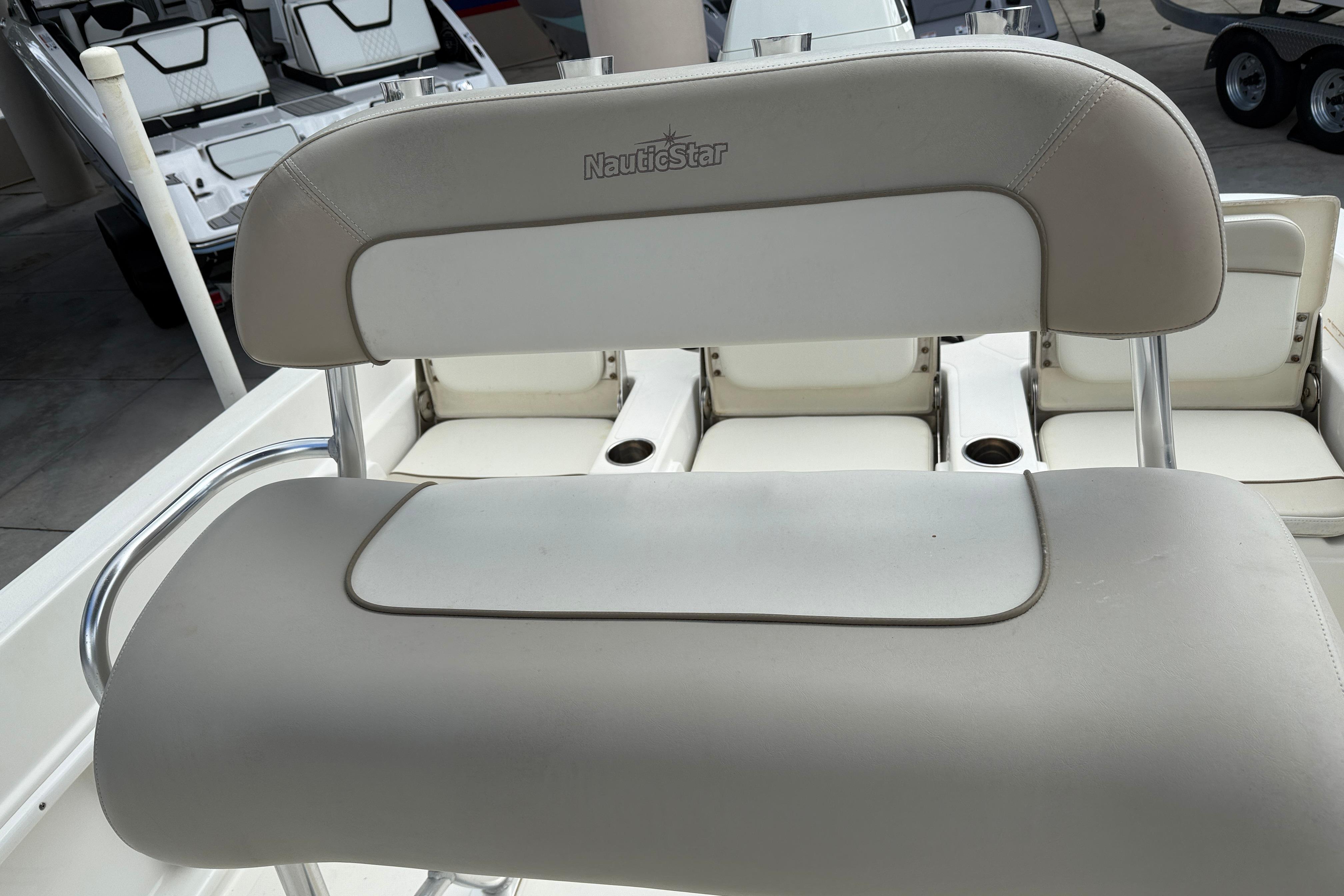2015 NauticStar 231 Coastal boat seat with white and beige upholstery.