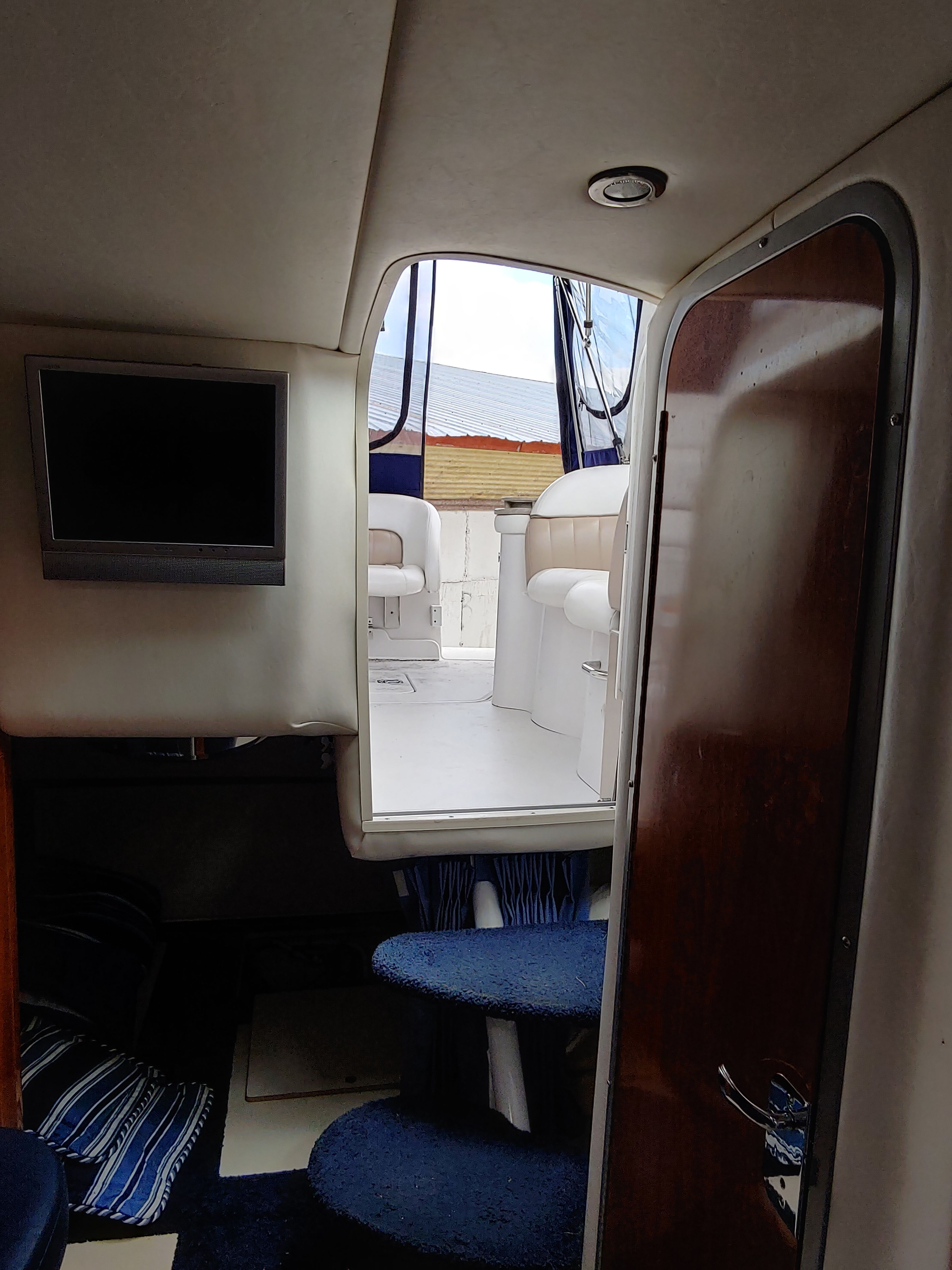 Interior view of a yacht with stairs and seating area.
