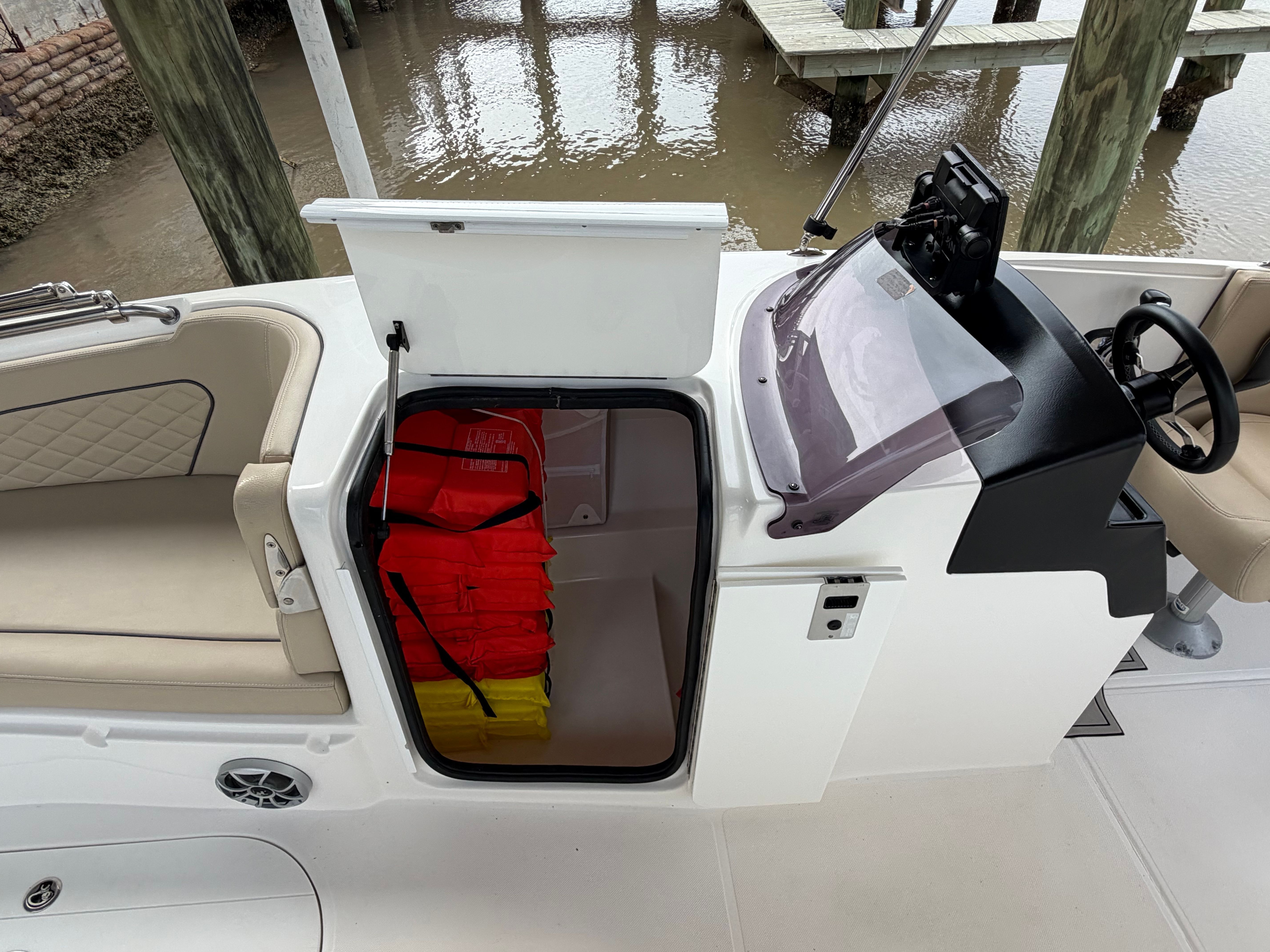 2021 Sea Pro Citation boat with open storage and life jackets.