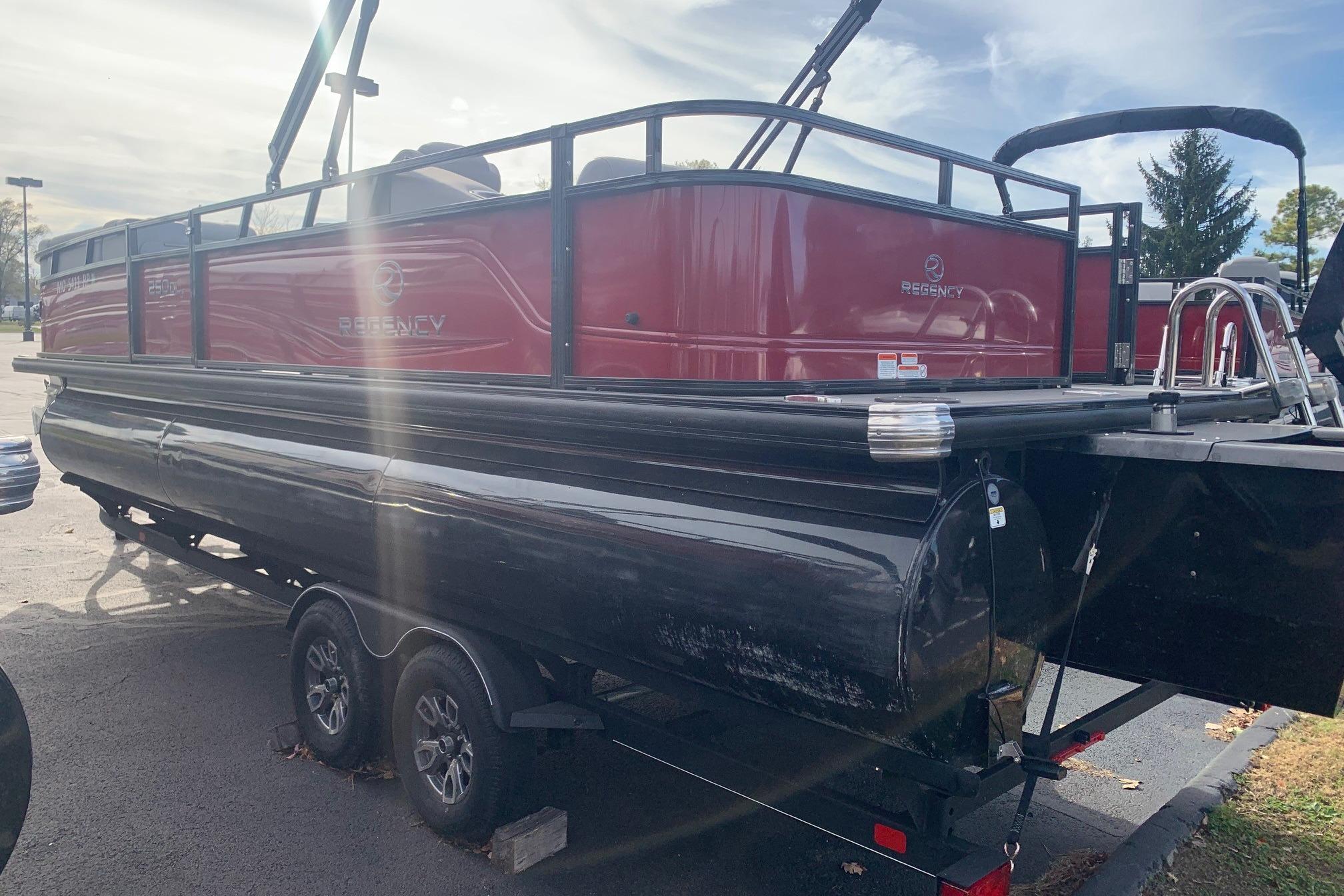 2024 Regency 250 DL3 pontoon boat on trailer, red and black design.