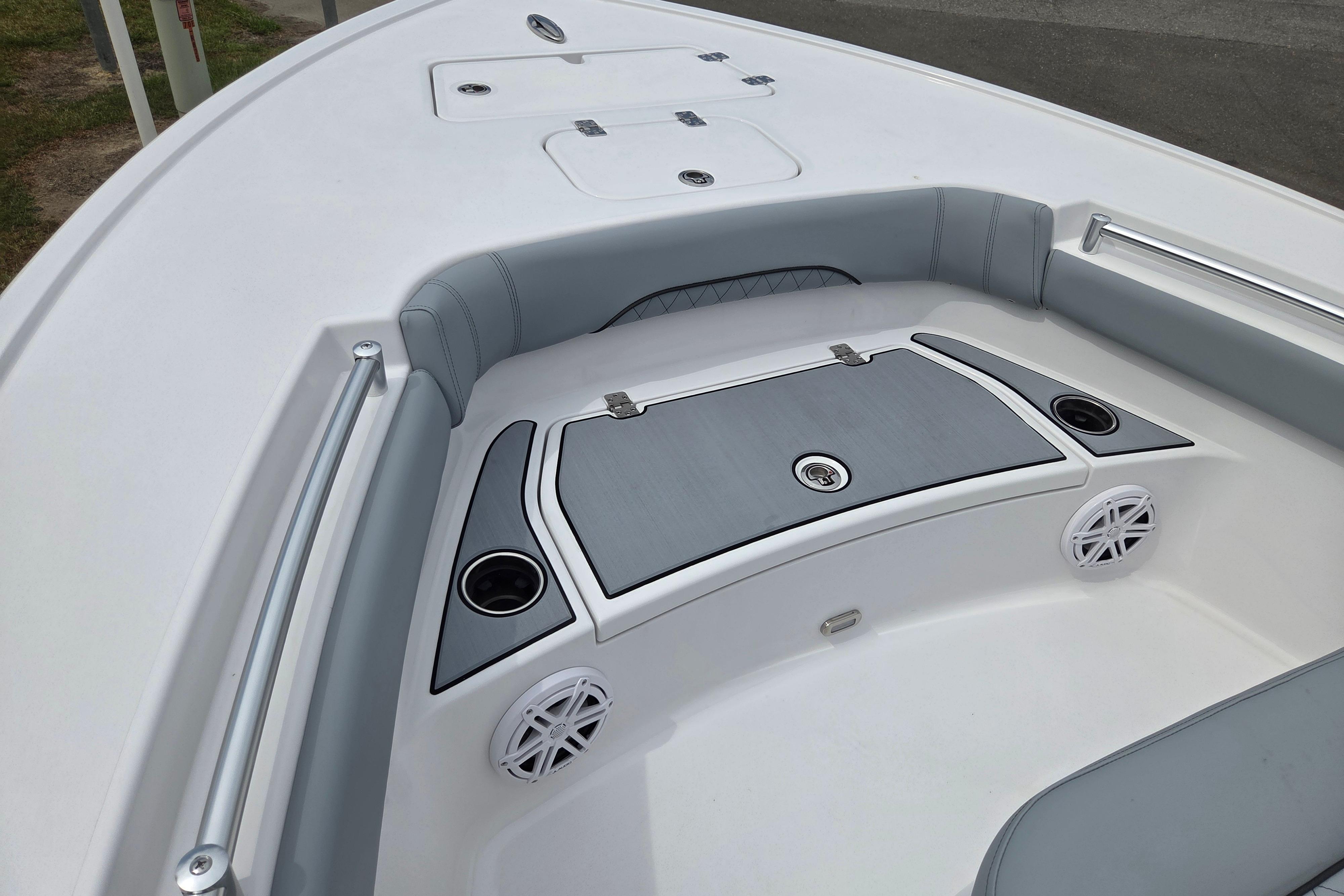 2026 Sportsman Masters 247OE Bay Boat interior with seating, speakers, and storage compartments.