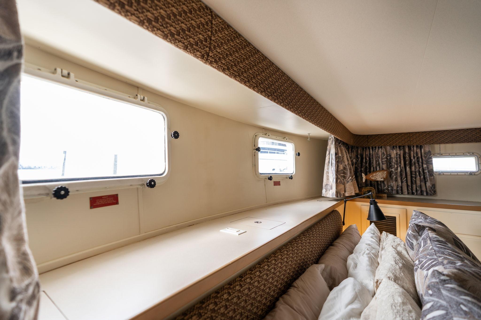 Interior of 1986 Hatteras 63 Motor Yacht with cozy cabin and large windows.