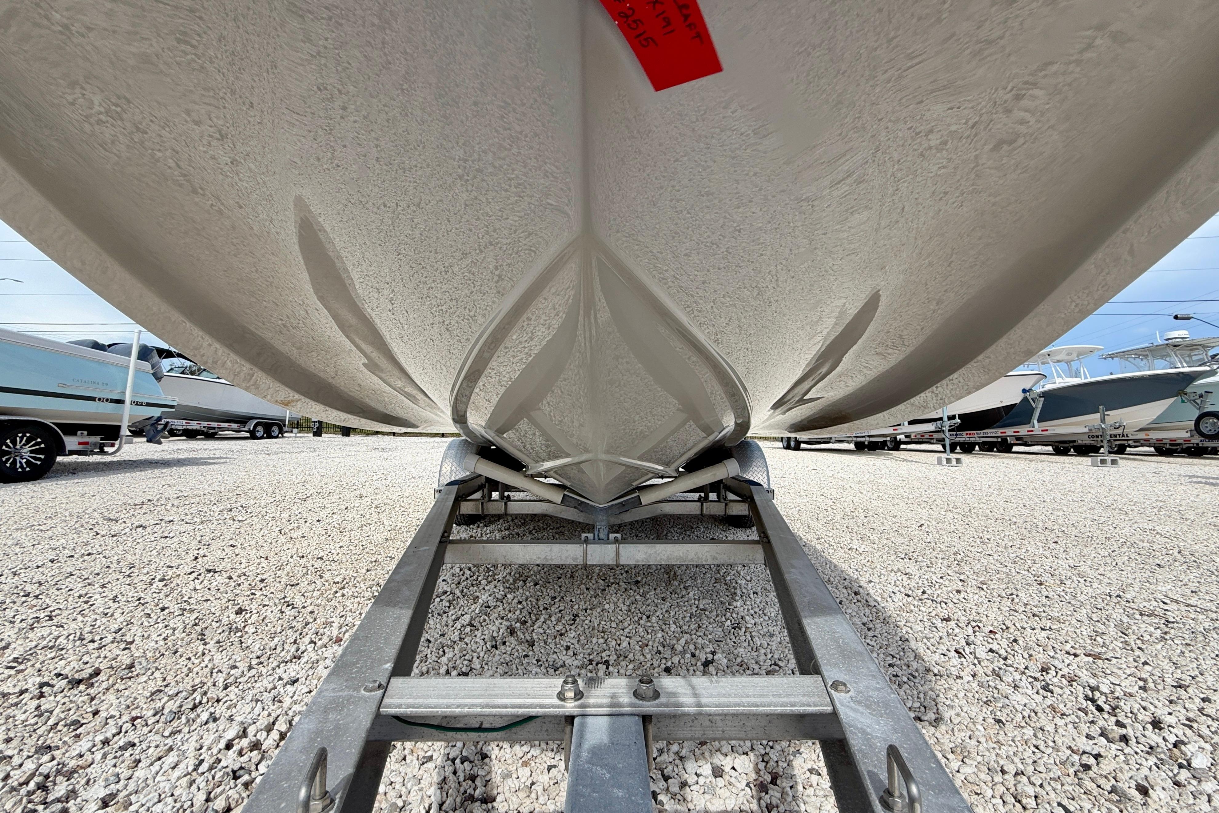 2021 Starcraft SVX 191 OB boat hull on trailer, parked on gravel lot.