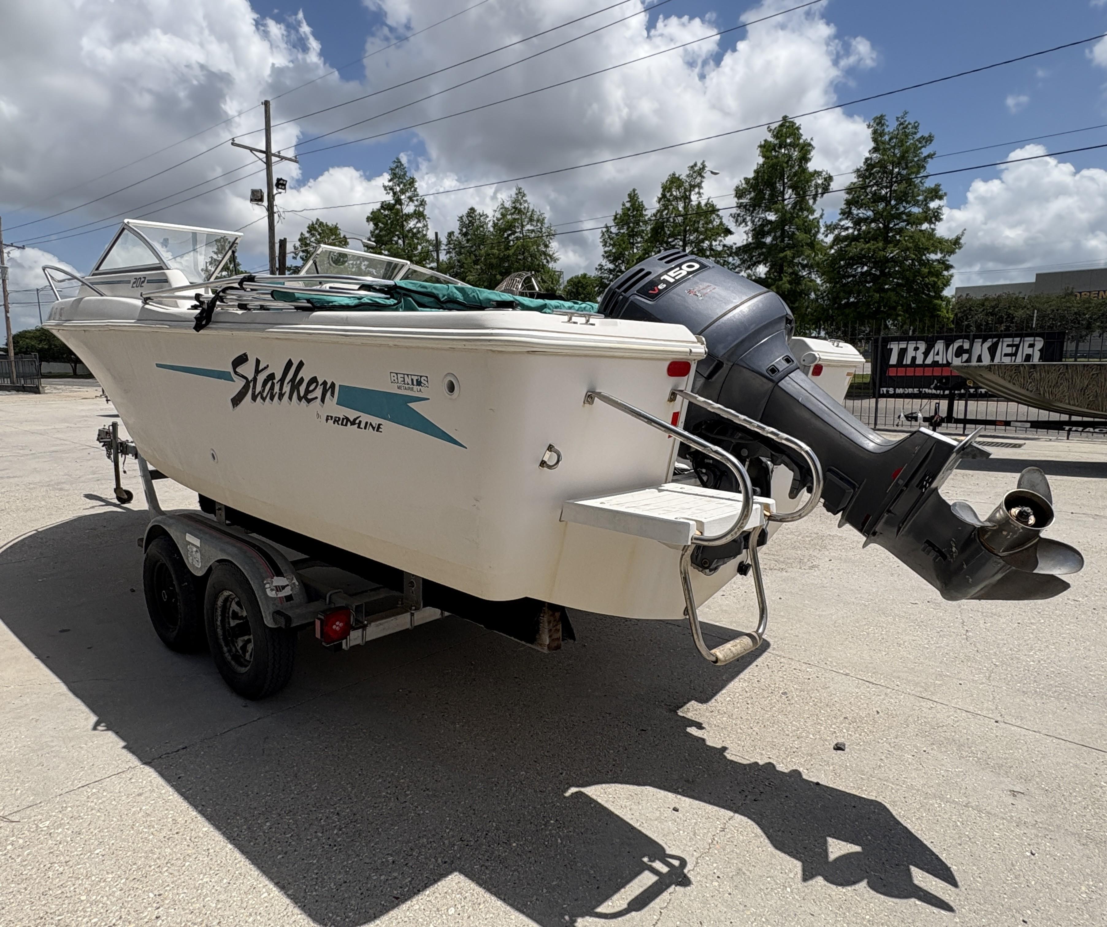 1996 Pro-Line 202 Stalker boat on trailer, featuring an outboard motor, under a partly cloudy sky.
