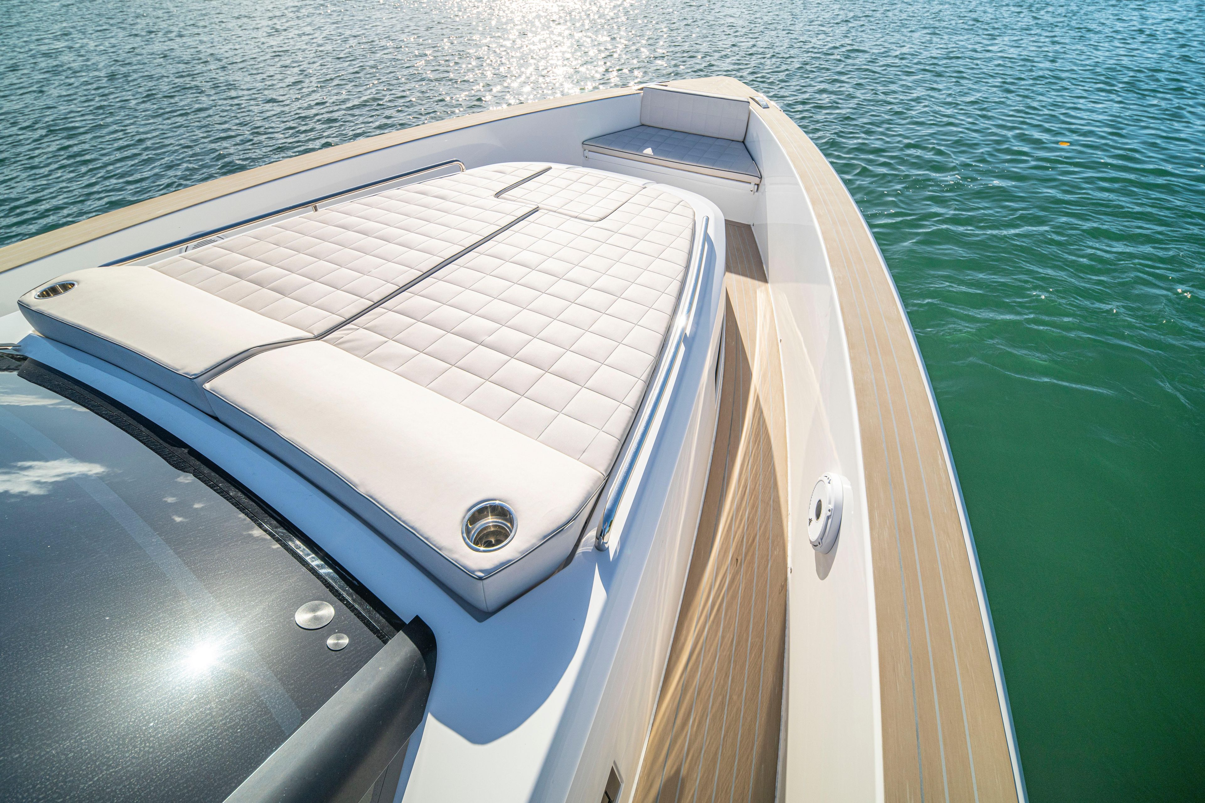2024 Pardo Yachts P43 deck with sunbed, cruising on calm blue waters.