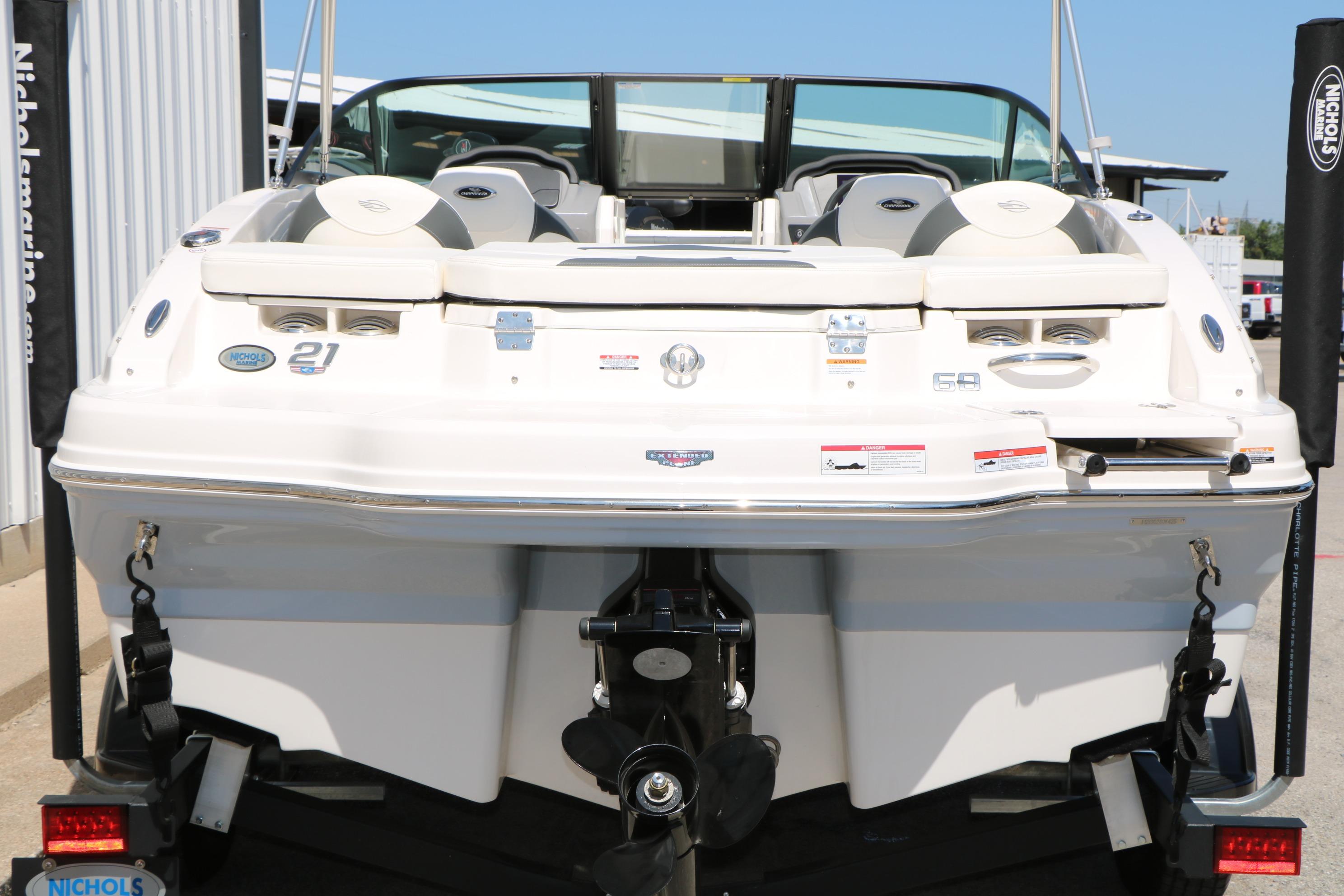 2025 Chaparral 21 SSi Ski & Fish boat, rear view, on trailer at dealership.