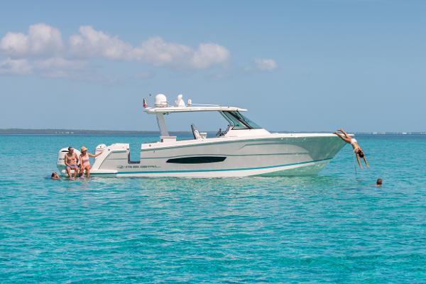 Manufacturer Provided Image: 2026 Regal 38 SAV boat with people enjoying the ocean.