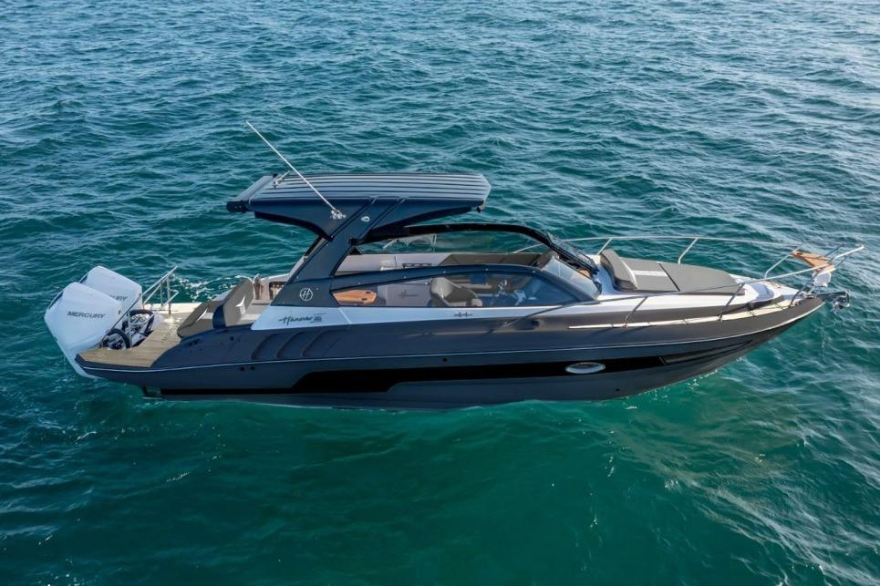 2027 Hanover 305 boat cruising on open water, featuring sleek design and modern amenities.