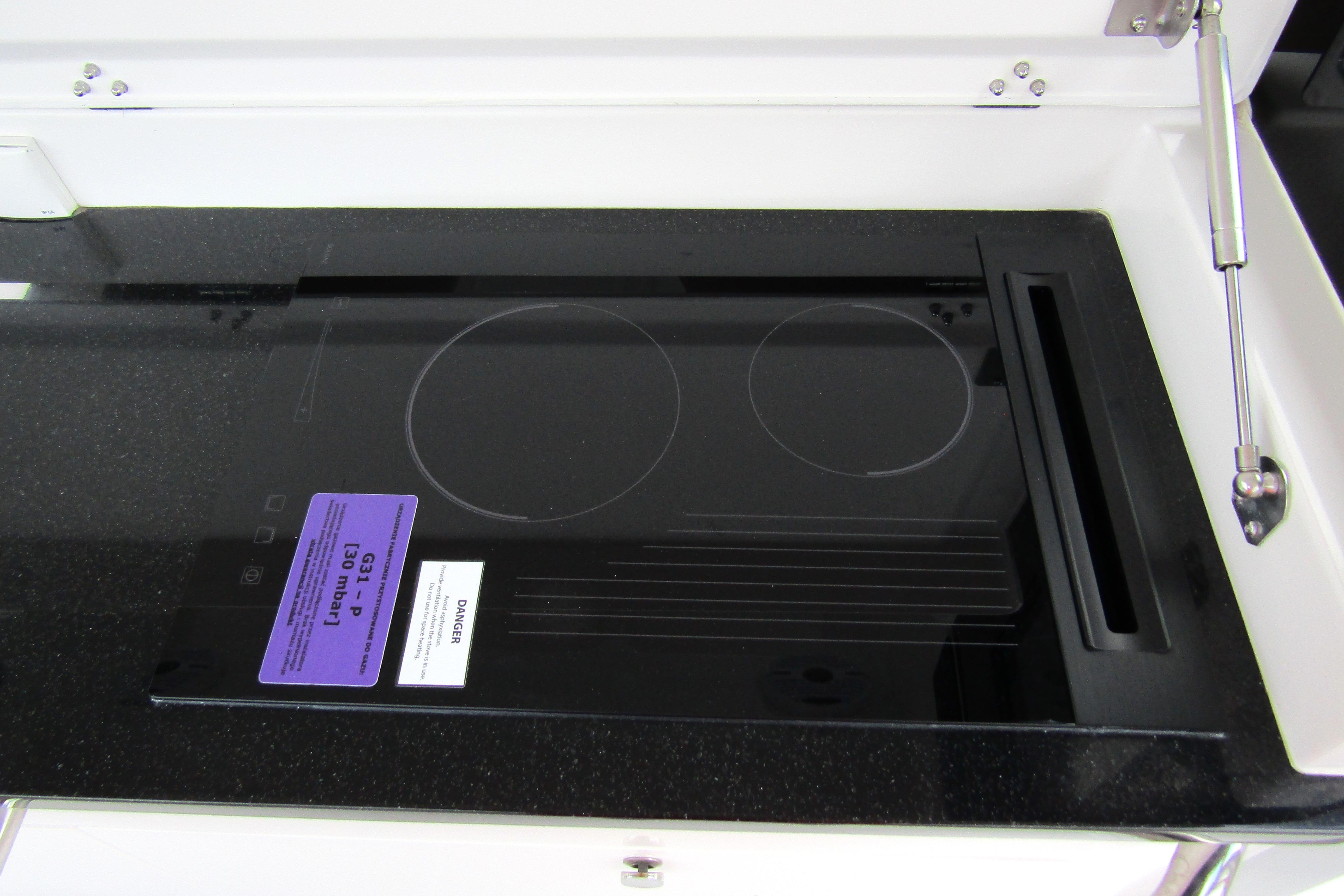 Built-in stovetop on Nimbus Tender 11 yacht, 2025 model, with sleek black finish.