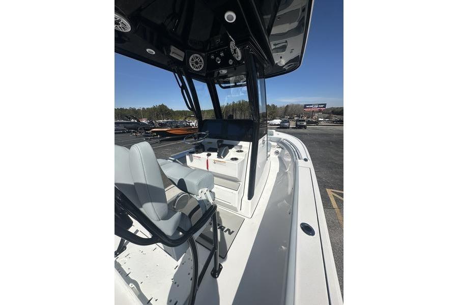 2026 Sportsman Masters 247 Bay Boat interior with seating and console, parked outdoors.