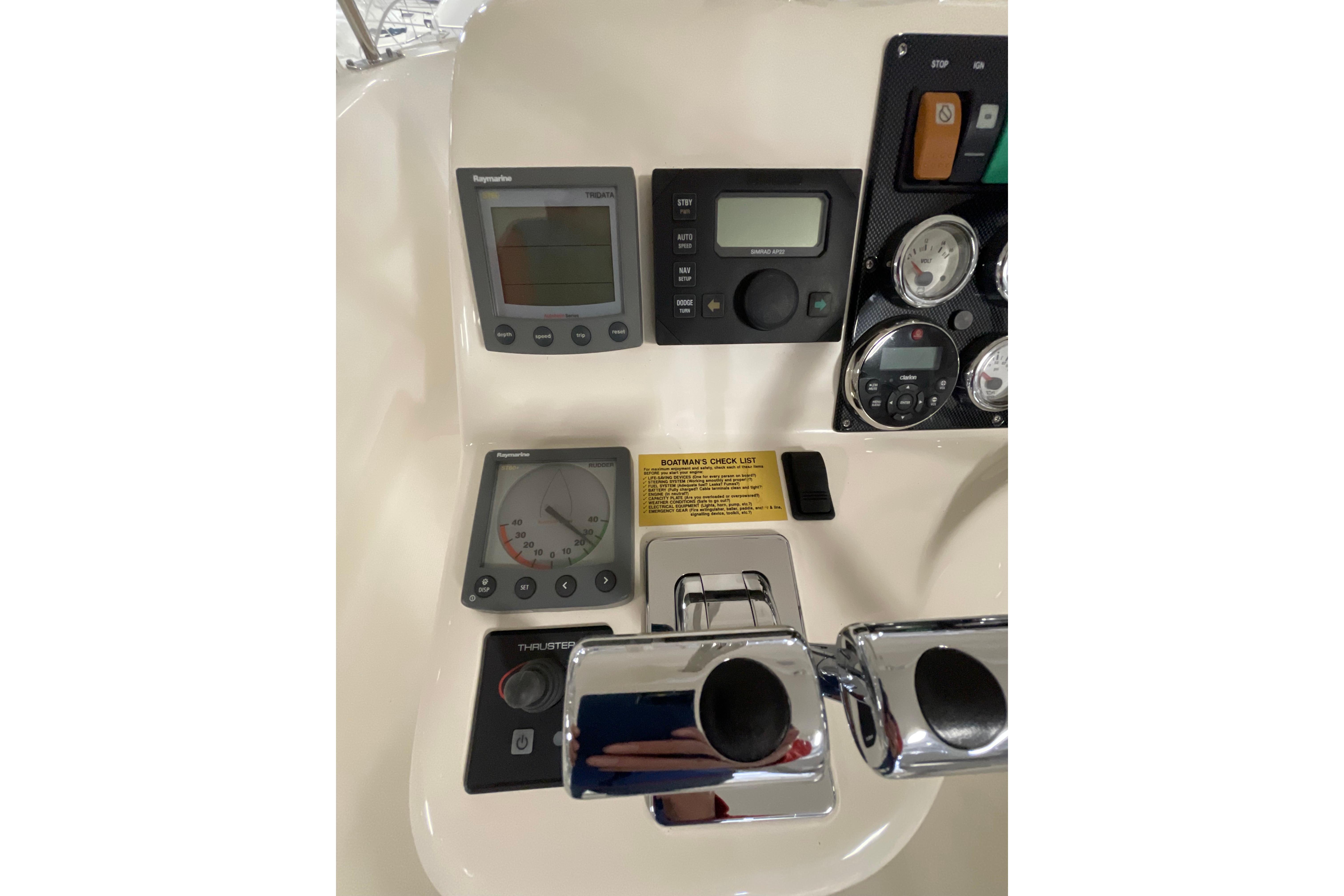 Control panel of 2002 Riviera 34 Convertible boat with gauges and switches.